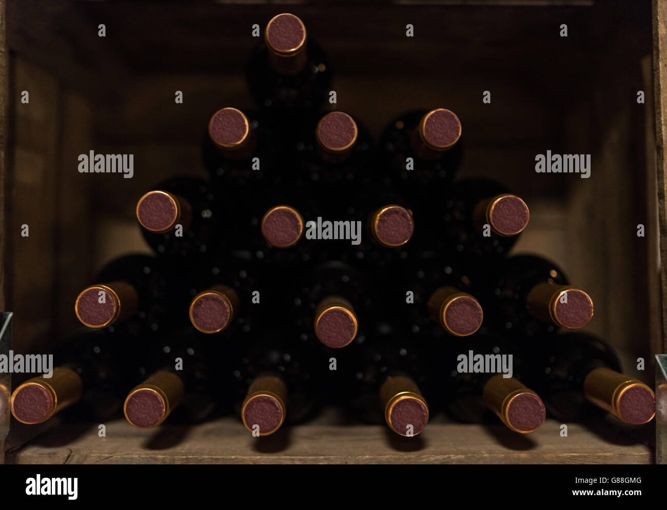 Stack of red wine bottles on shelf Stock Photo Alamy