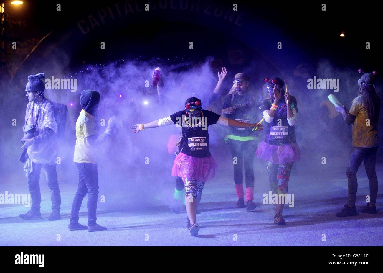 The Color Run Night. People take part in The Color Run Night at Queen Elizabeth Olympic Park, east London. Stock Photo
