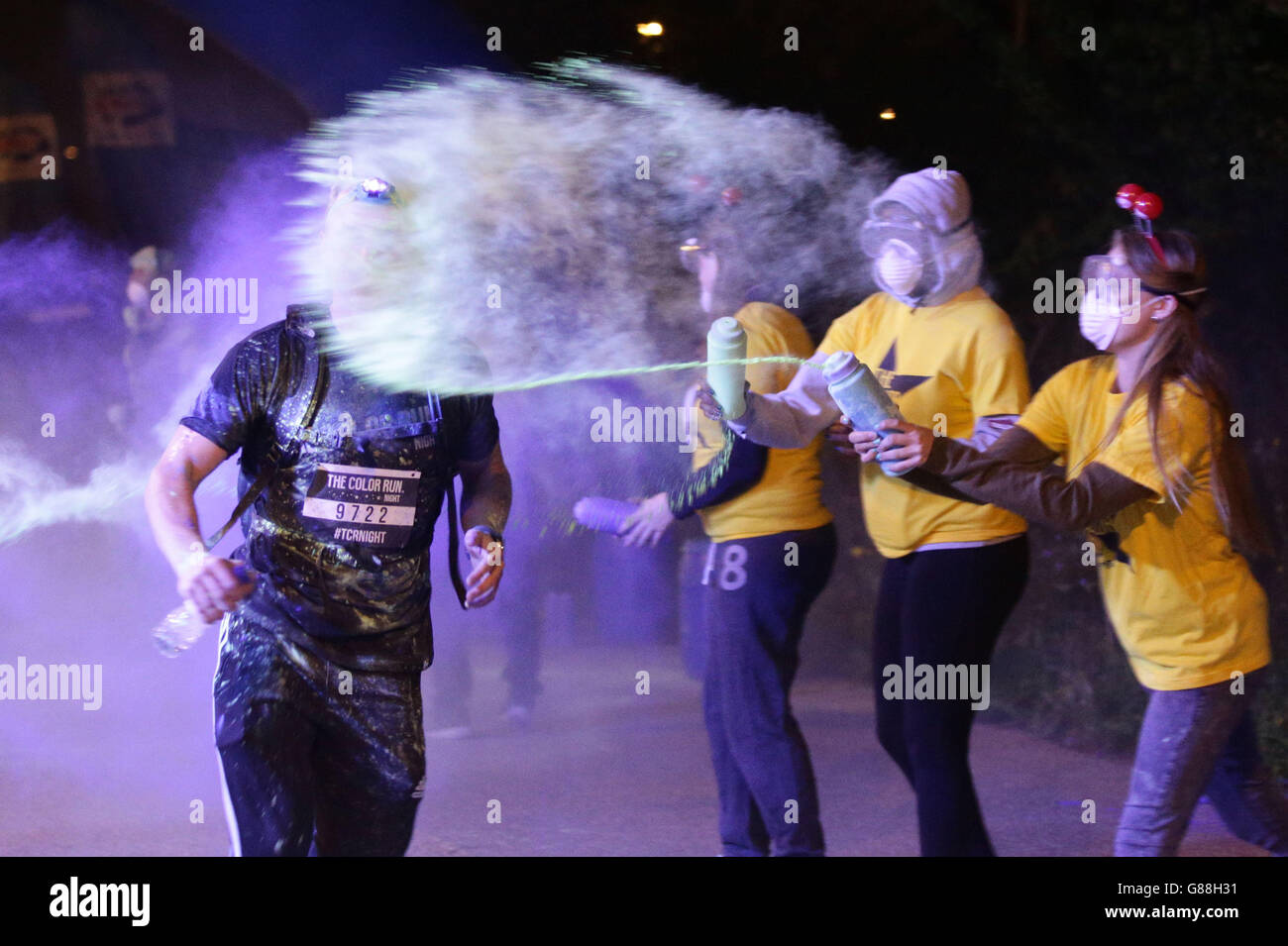 People take part in The Color Run Night at Queen Elizabeth Olympic Park, east London. Stock Photo
