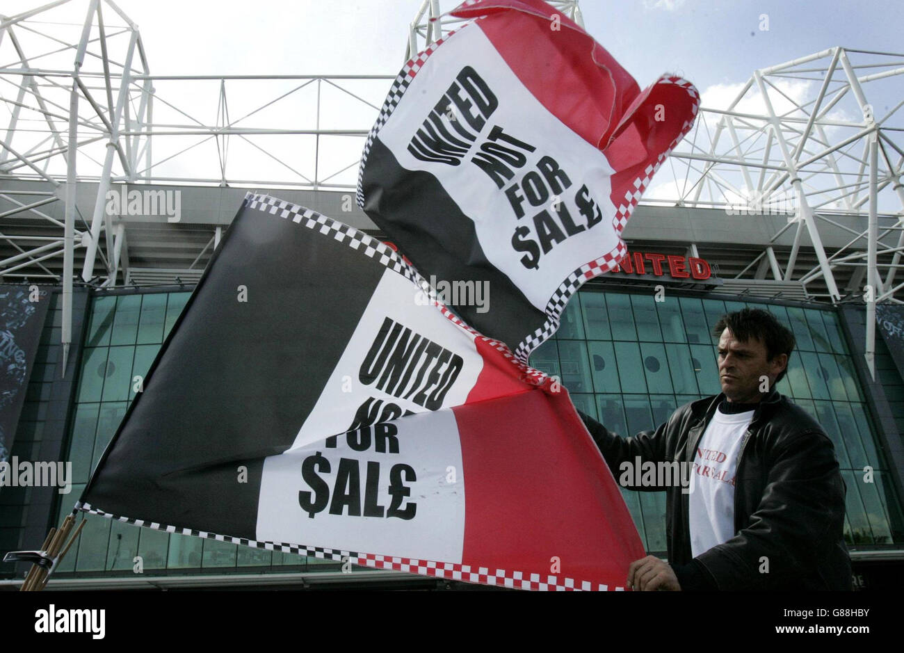 Soccer - Manchester United takeover - Old Trafford. A Manchester United fan sells anti-Glazer flag. Stock Photo