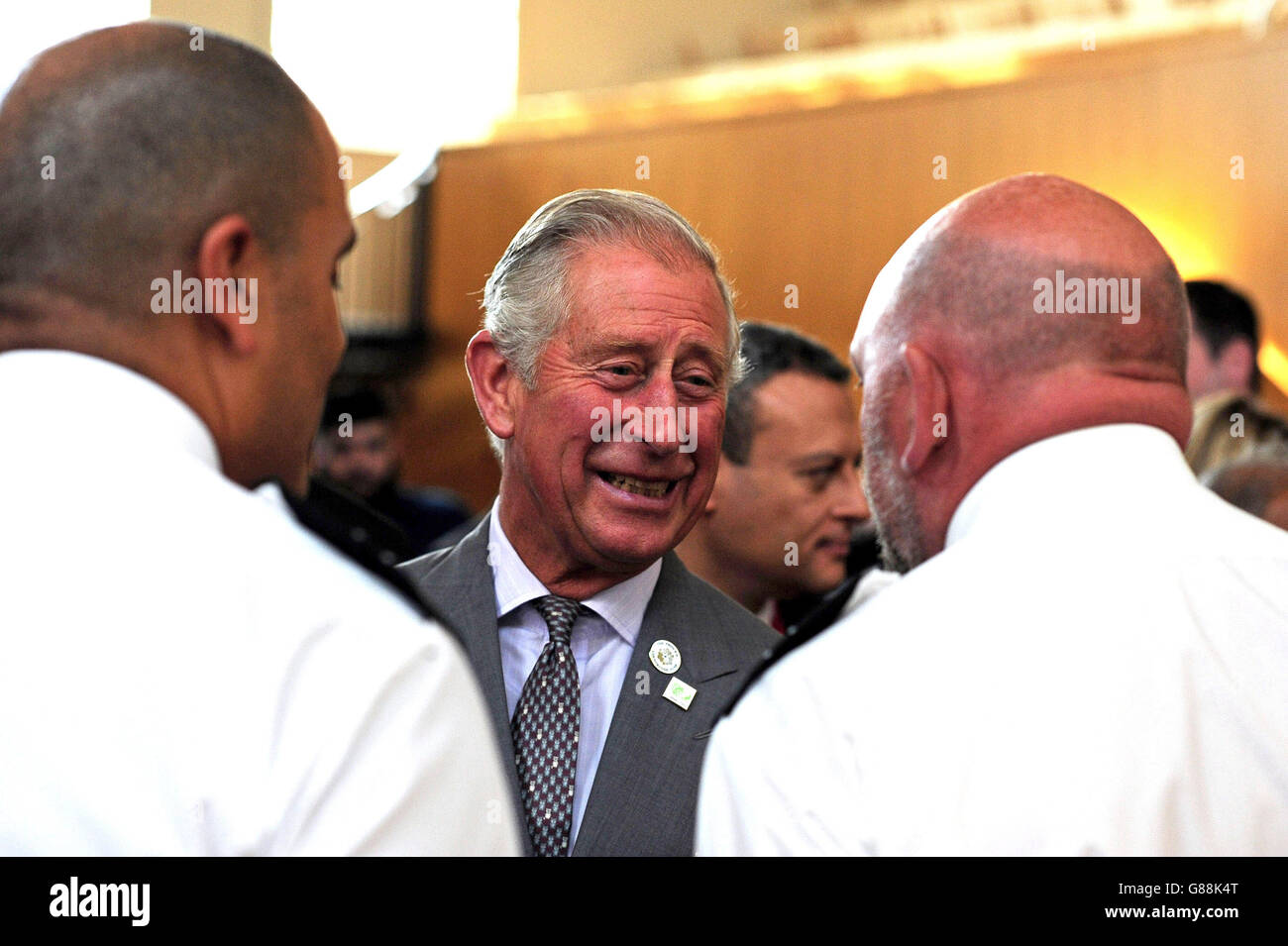 The Prince of Wales (centre) speaks to prison guards involved in his