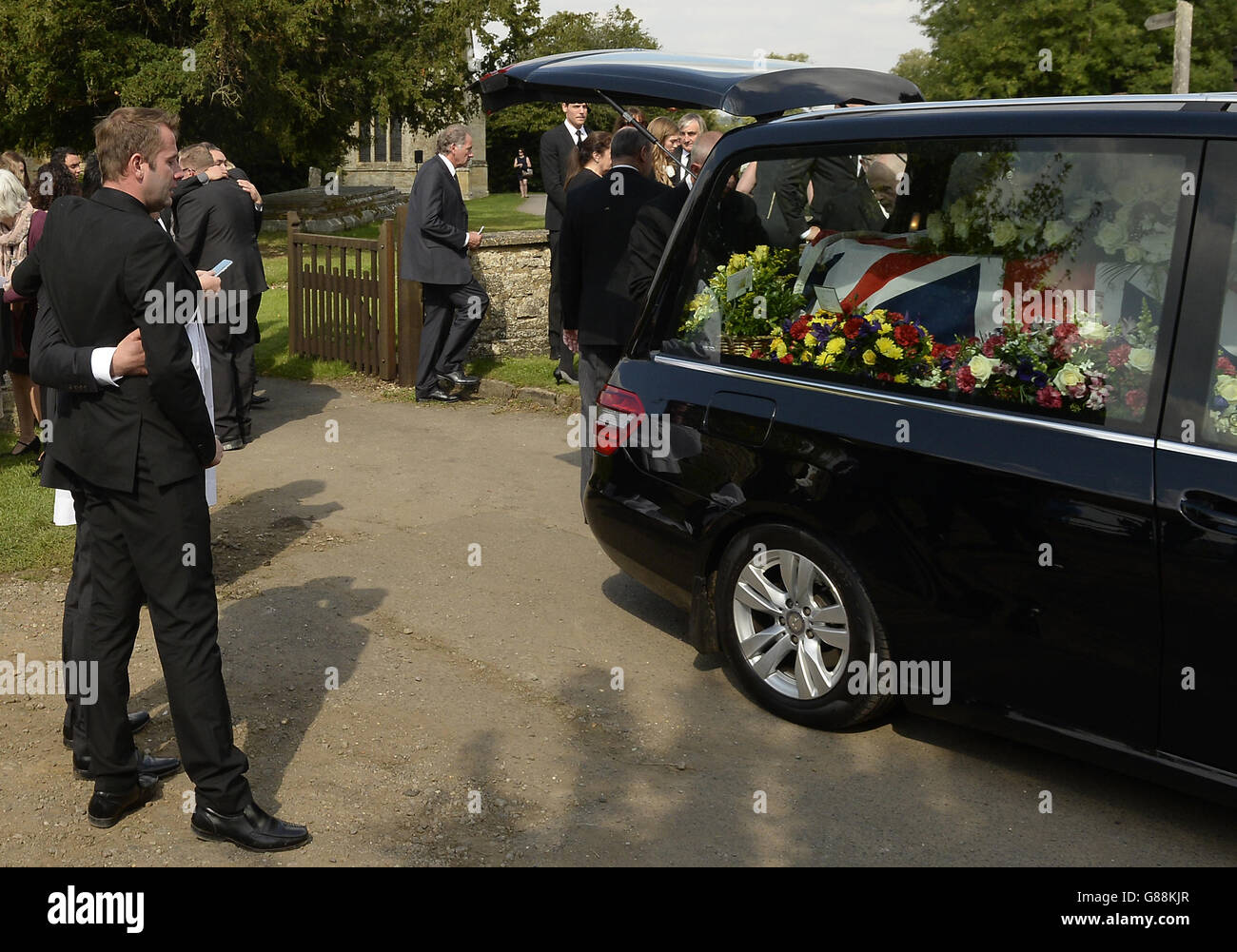 The coffin of Justin Wilson sits in the hearse after his funeral at St James the Great Church in Paulerspury, Northamptonshire. Stock Photo