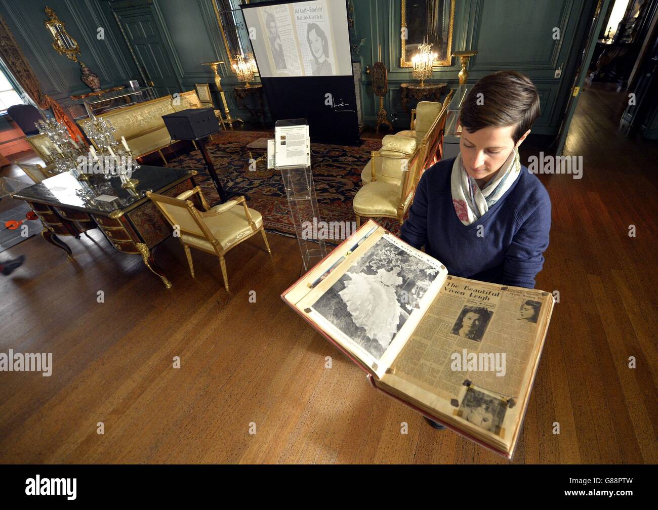 Exhibition manager Alexandra Kaspar looks at a scrap book put together by actress Vivien Leigh, part of the new exhibition Vivien Leigh: Public Faces Private Lives organised by the Victoria and Albert Museum at the National Trust's Treasurer's House in York. Stock Photo