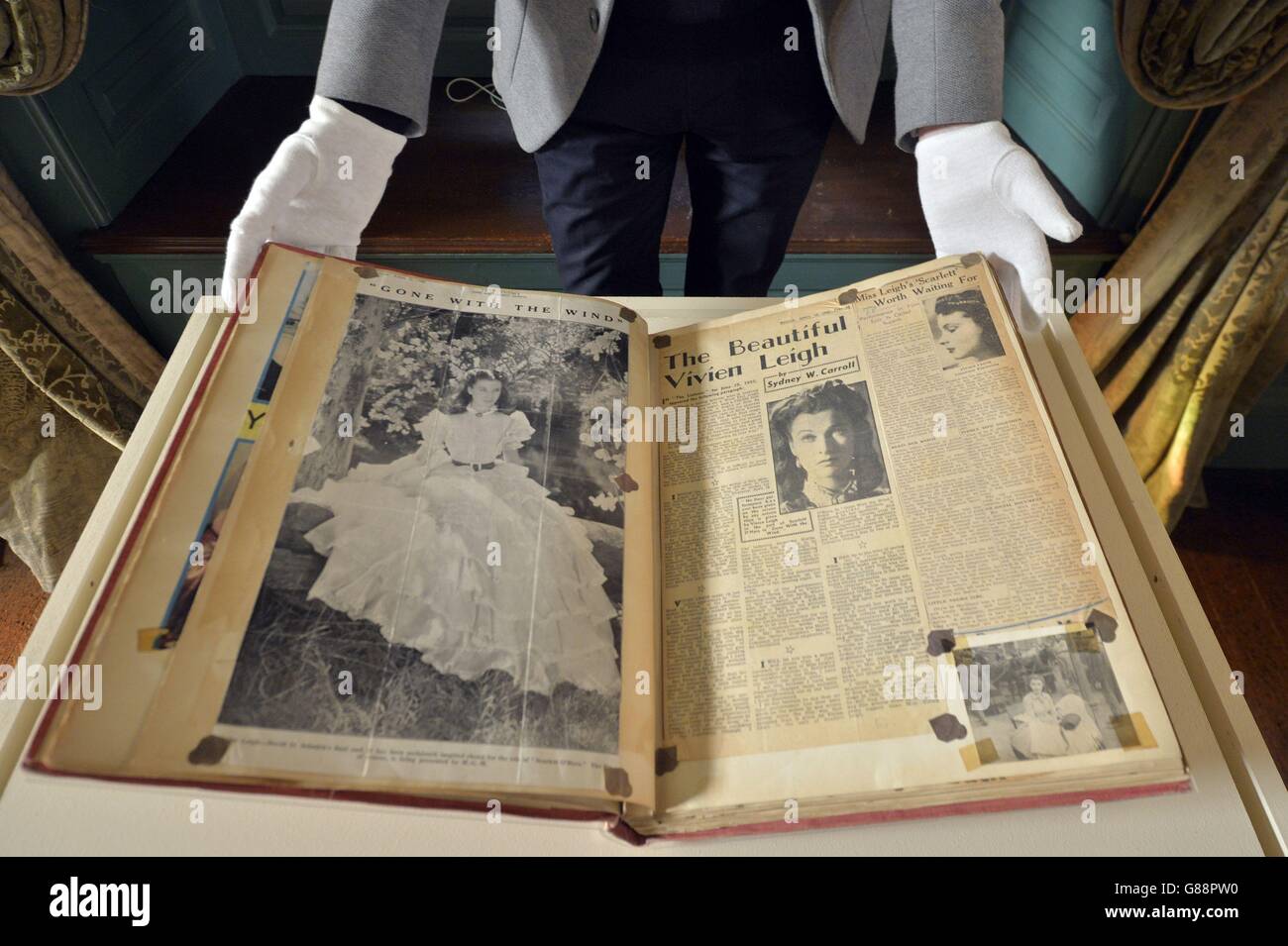 Curator Keith Lodwich looks at a scrap book put together by actress Vivien Leigh, part of the new exhibition Vivien Leigh: Public Faces Private Lives organised by the Victoria and Albert Museum at the National Trust's Treasurer's House in York. Stock Photo