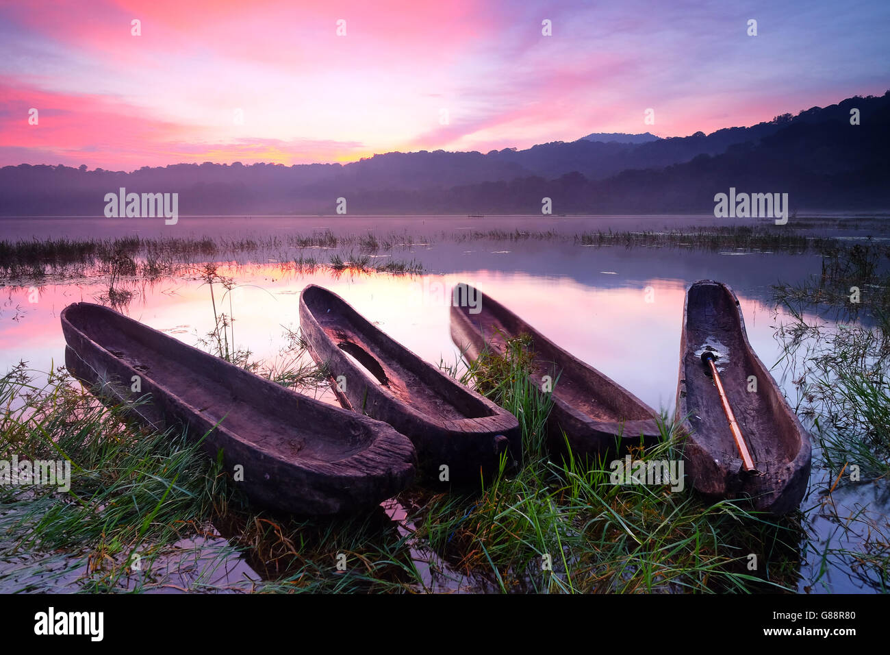 Four boats at sunset, Tamblingan Lake, Bali, Indonesia Stock Photo