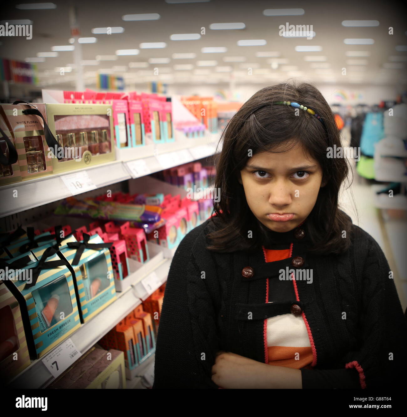 a young girl standing in a mall Stock Photo - Alamy
