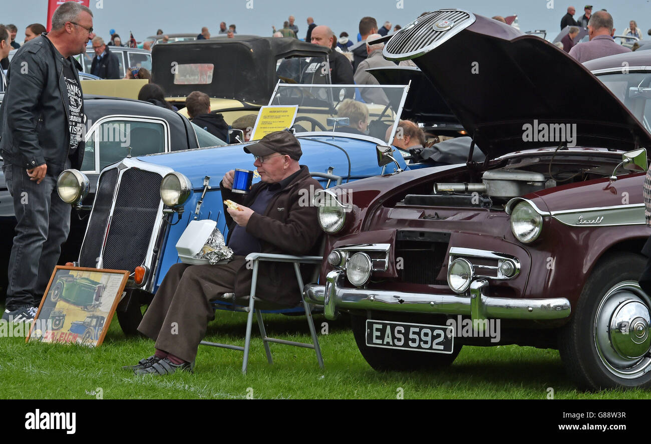 Photo. A car owner takes a break at the Whitley Bay Classic Car Show
