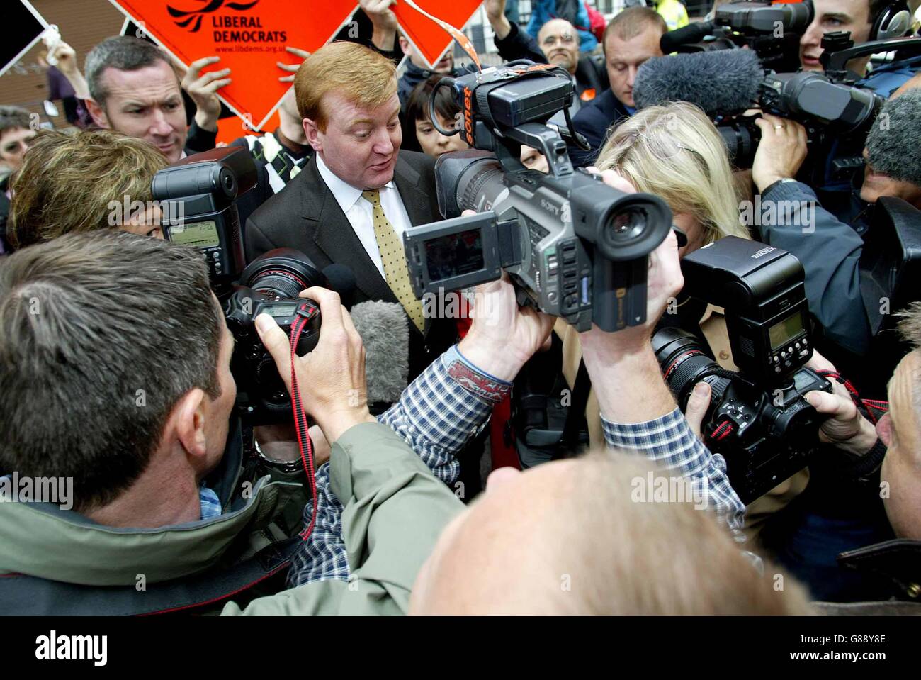 Leader Charles Kennedy struggles as he pushes through a media pack during a visit to Brent. Stock Photo