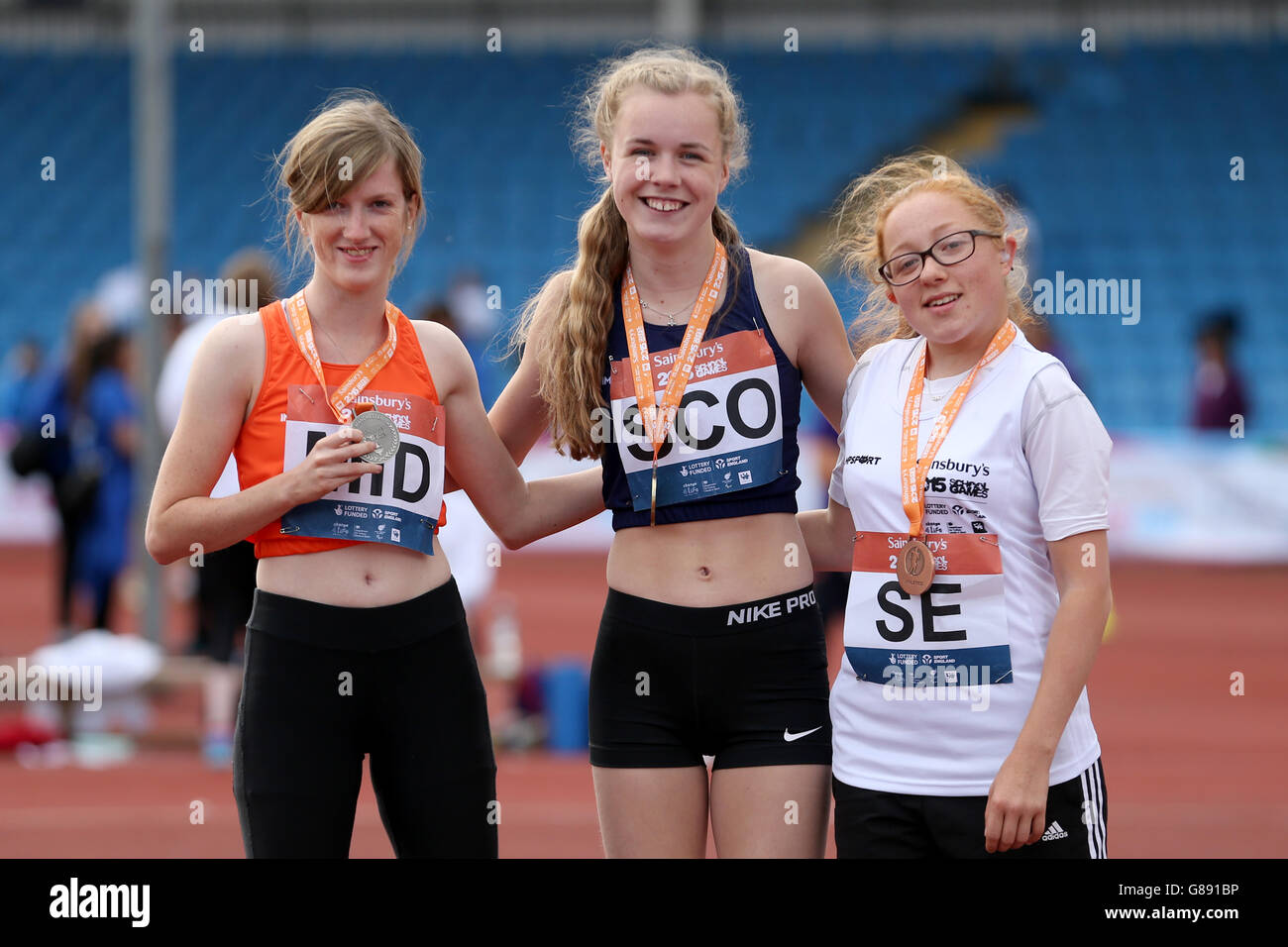 (l-r) England Midland's Sophie Hahn, Scotland's Maria Lyle and England South East's Maria Verdeille receive their girls ambulant 200m medals during the medal ceremony at the Sainsbury's 2015 School Games at the Manchester Regional Arena. Stock Photo