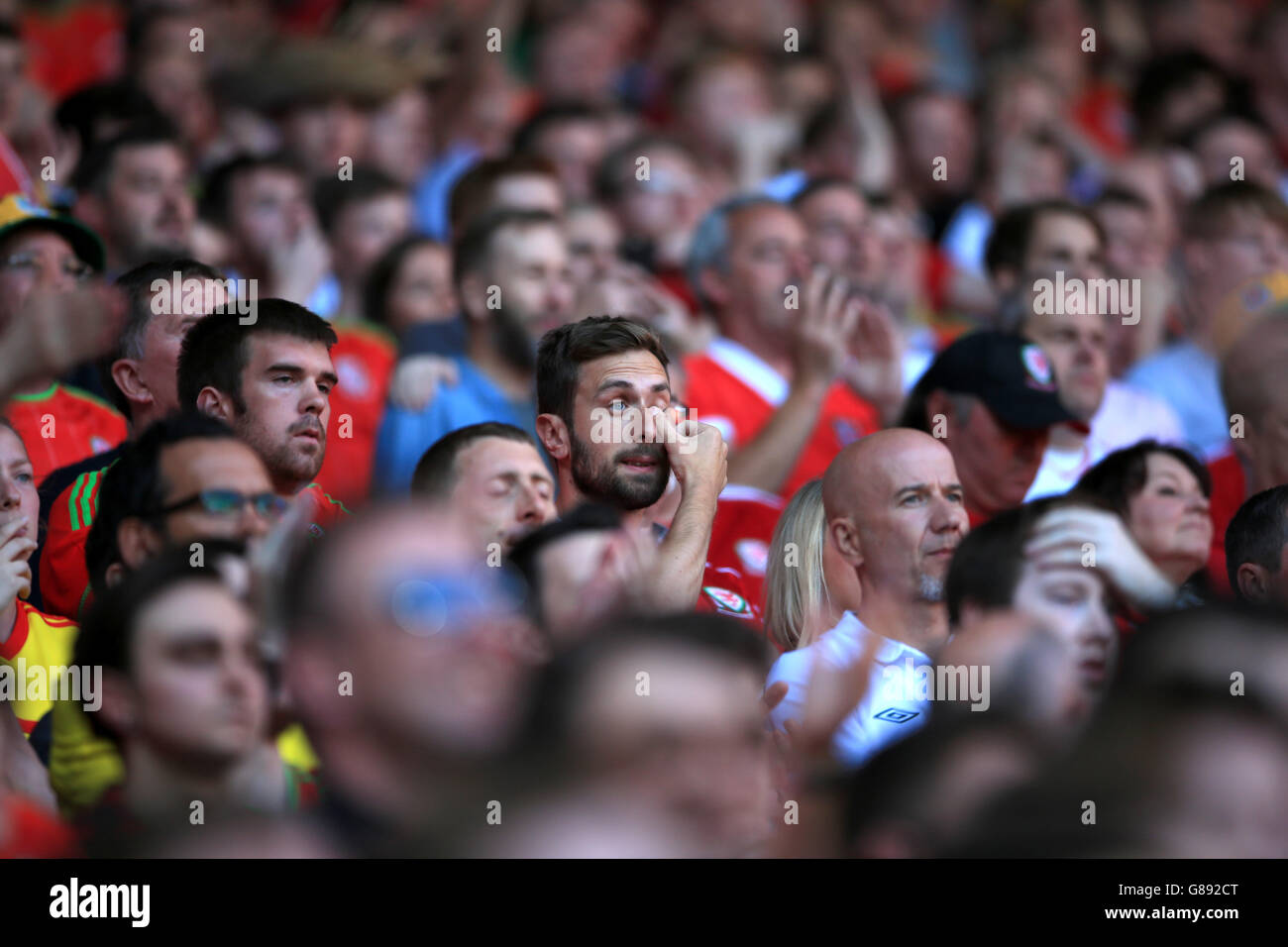 *Alternate Crop* A fan wipes a tear from his eye during the national anthems, before the UEFA Euro 2016 qualifying match at the Cardiff City Stadium, Cardiff. Stock Photo