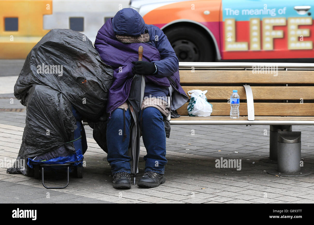 A homeless person rests on a bench outside Imperial College, London ...