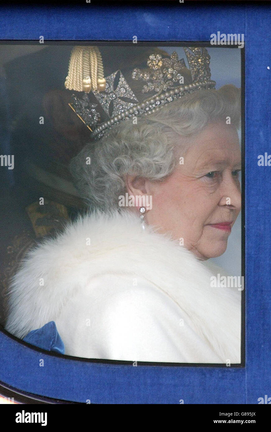 Britain's Queen Elizabeth II travels to the House of Lords in a horse-drawn carriage from Buckingham Palace, London, for the State Opening of Parliament. The Queen's Speech will set out the government's legislative programme for the new parliamentary session following the Labour Party's return to power in the General Election earlier this month. Stock Photo