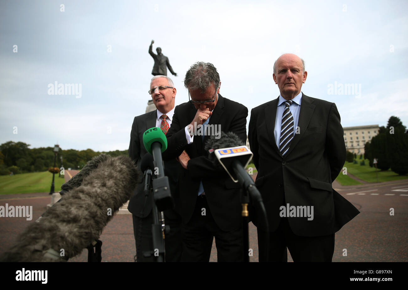 Ulster Unionist Party leader Mike Nesbitt (centre) alongside Danny Kennedy (left) and Michael McGimmpsey (right) speak to the media at Stormont in Belfast. Stock Photo