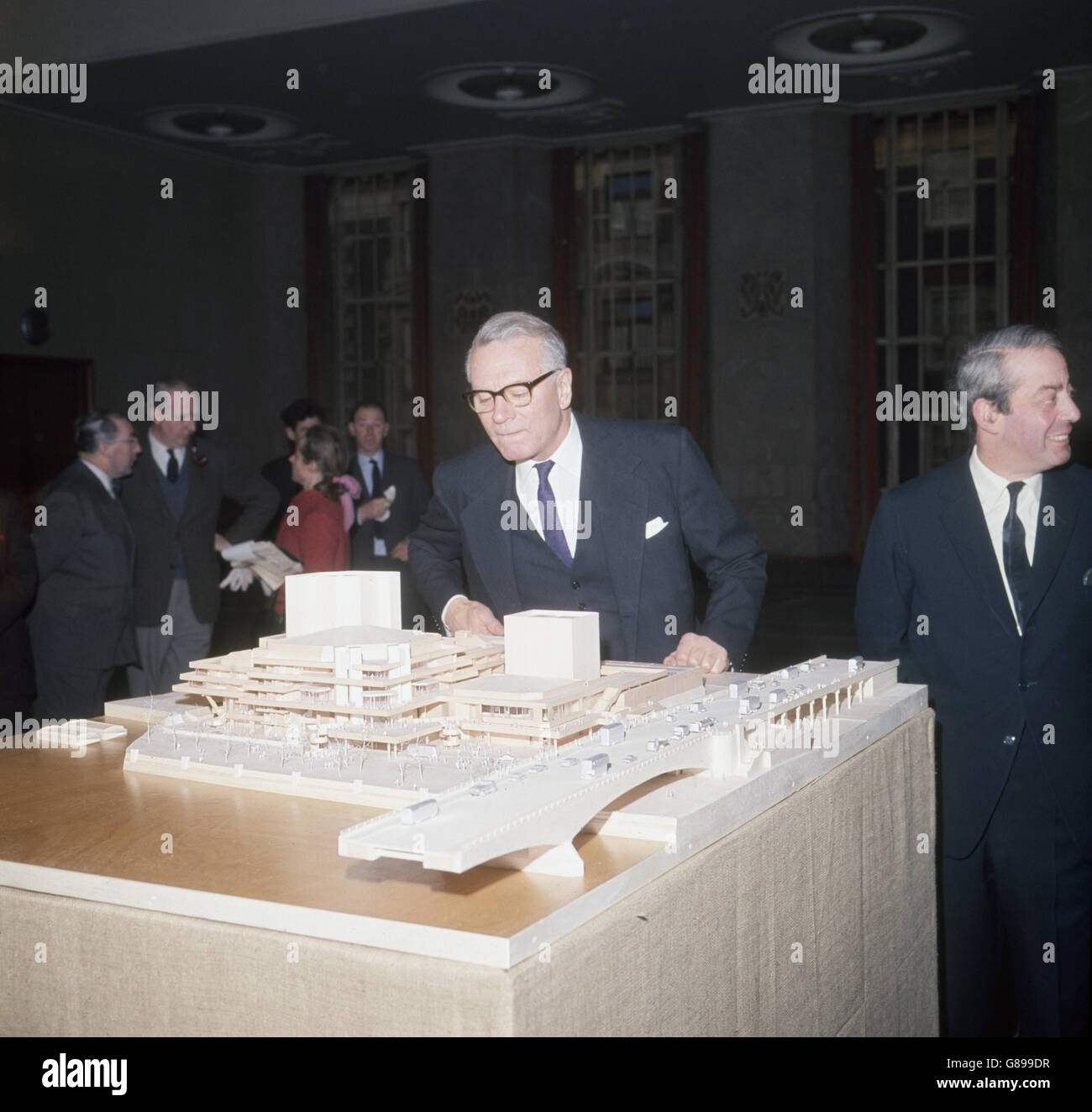 Sir Laurence Olivier, Director of the National Theatre Company, viewing a model of the new National Theatre building for the South Bank, London. Pictured right is the architect, Denys Lasdun. Stock Photo
