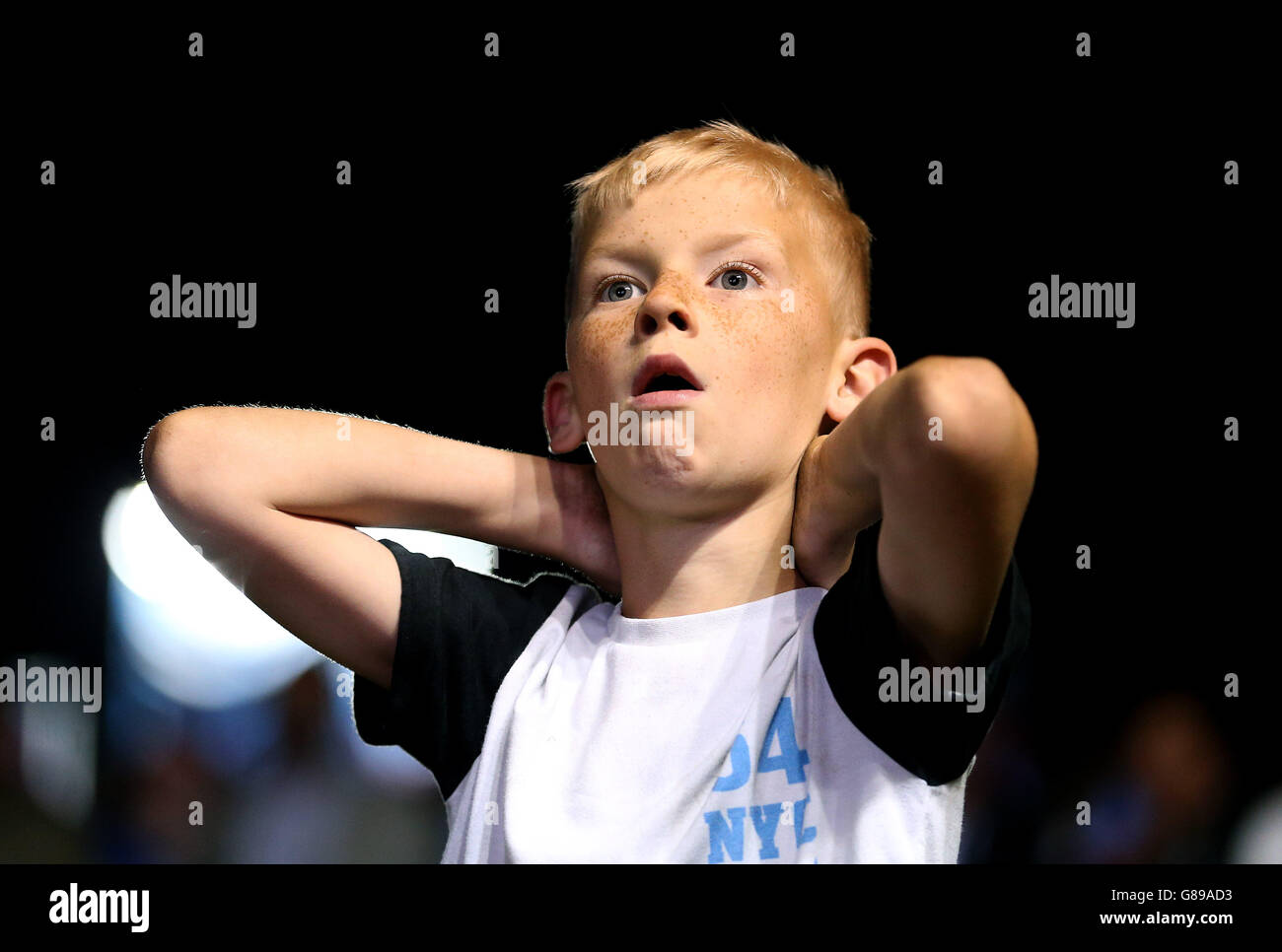 A young England fans celebrates while watching the game at the Fan zone