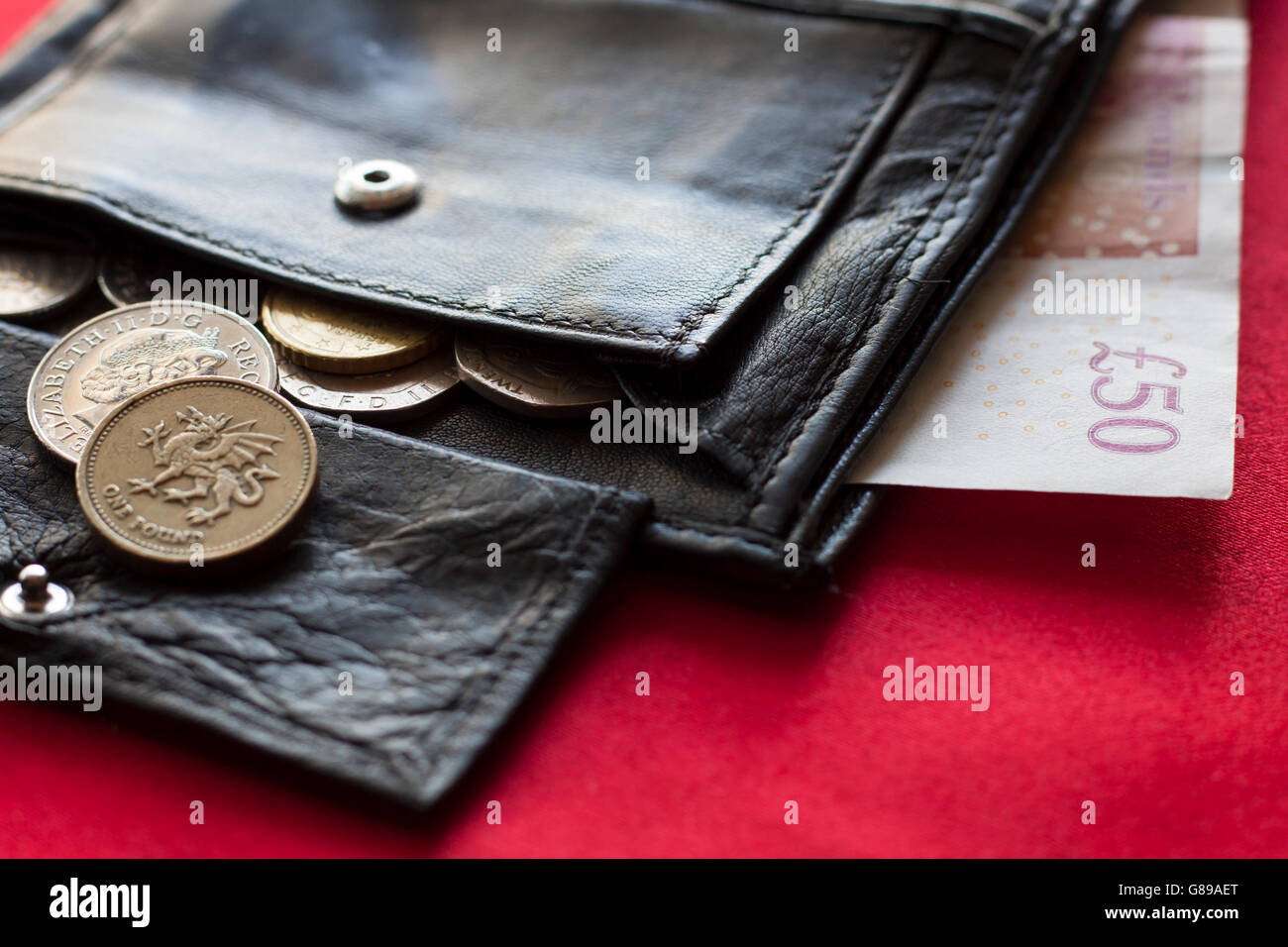 50 British pounds and coins in black wallet Stock Photo