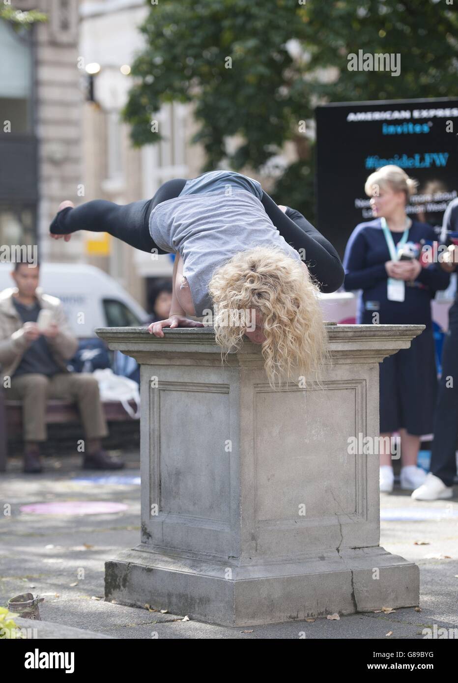 An employee from Starseeds performs in Golden Square during the Spring/Summer 2016 London Fashion Week in London. Stock Photo