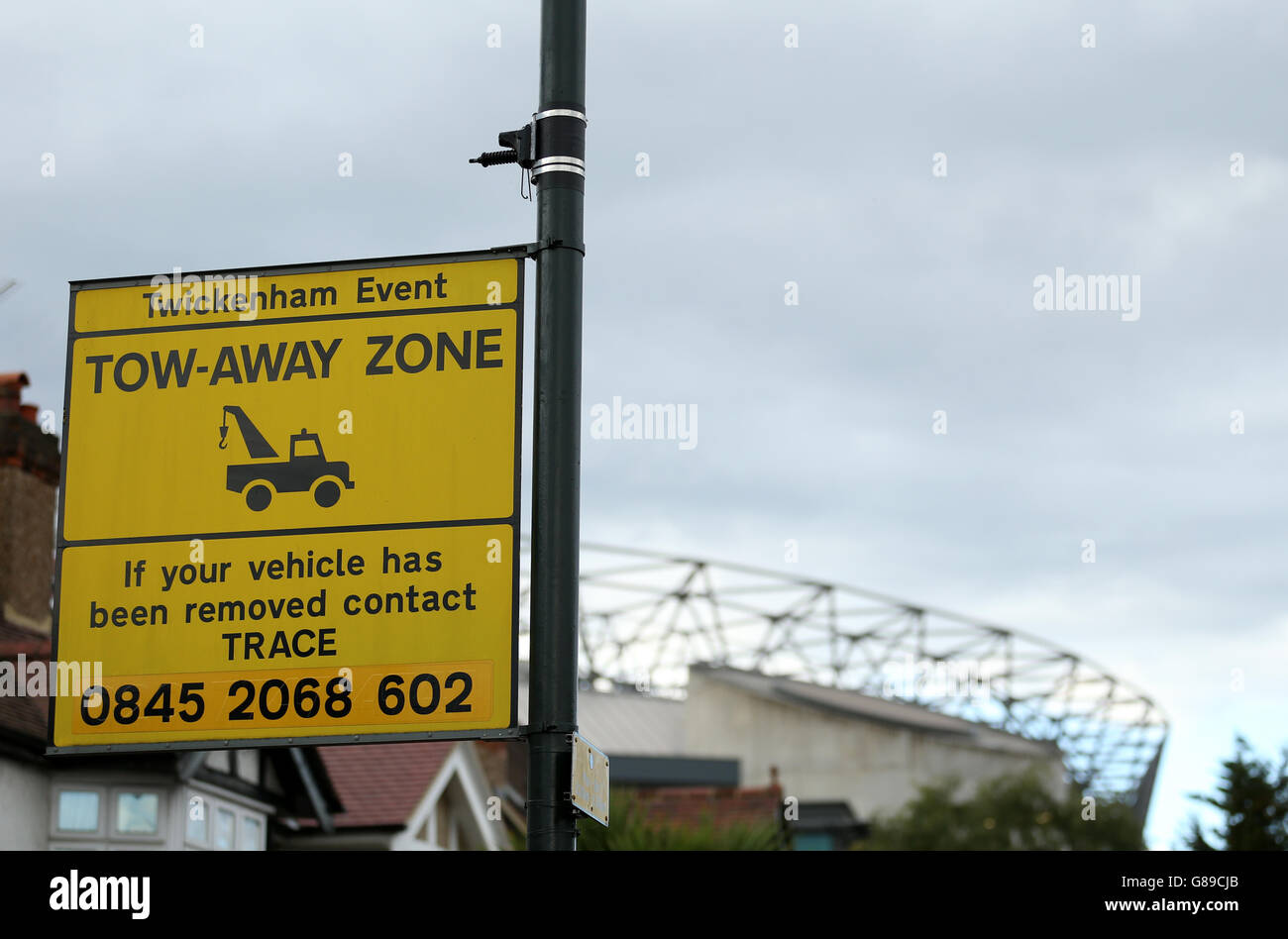 A traffic enforcement sign warning vehicle owners they are in a tow-away zone near Twickenham Stadium, London. Stock Photo
