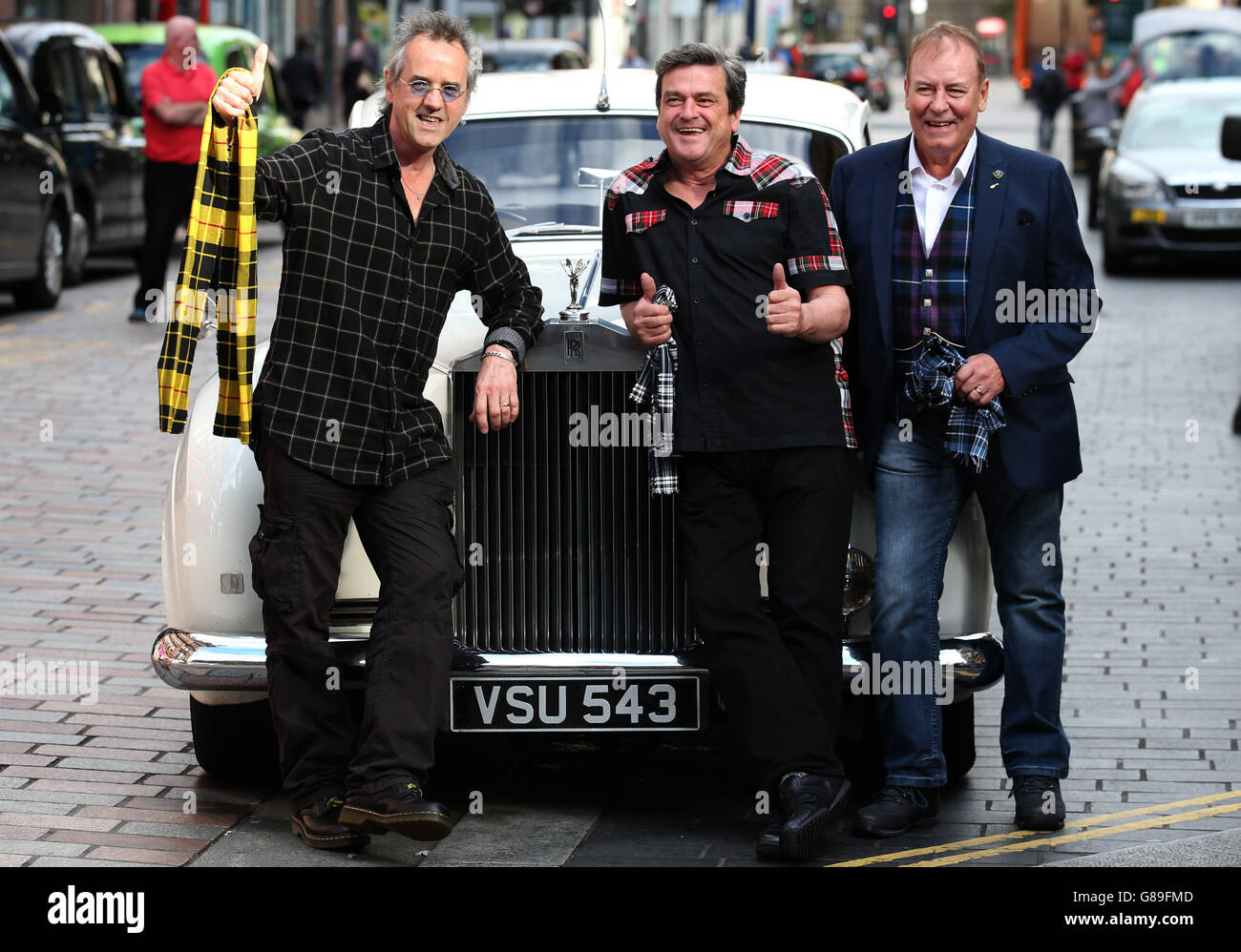 Bay City Rollers (left to right) Stuart Wood, Les McKeown and Alan Longmuir next to a Rolls Royce as they make the announcement of their reunion at Central Hotel in Glasgow. Stock Photo