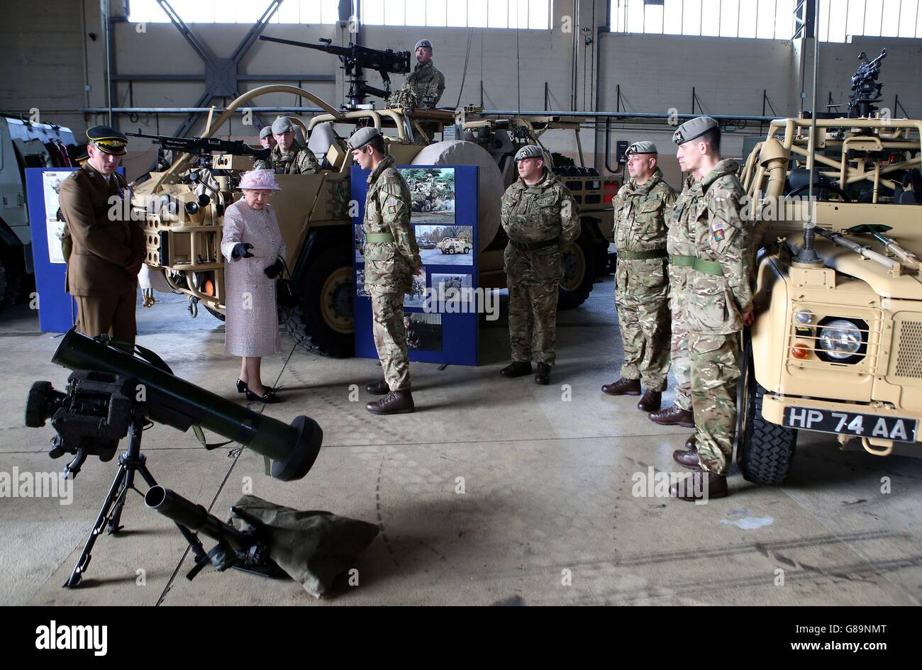 Queen Elizabeth II meets soldiers in a hanger during a visit to the ...