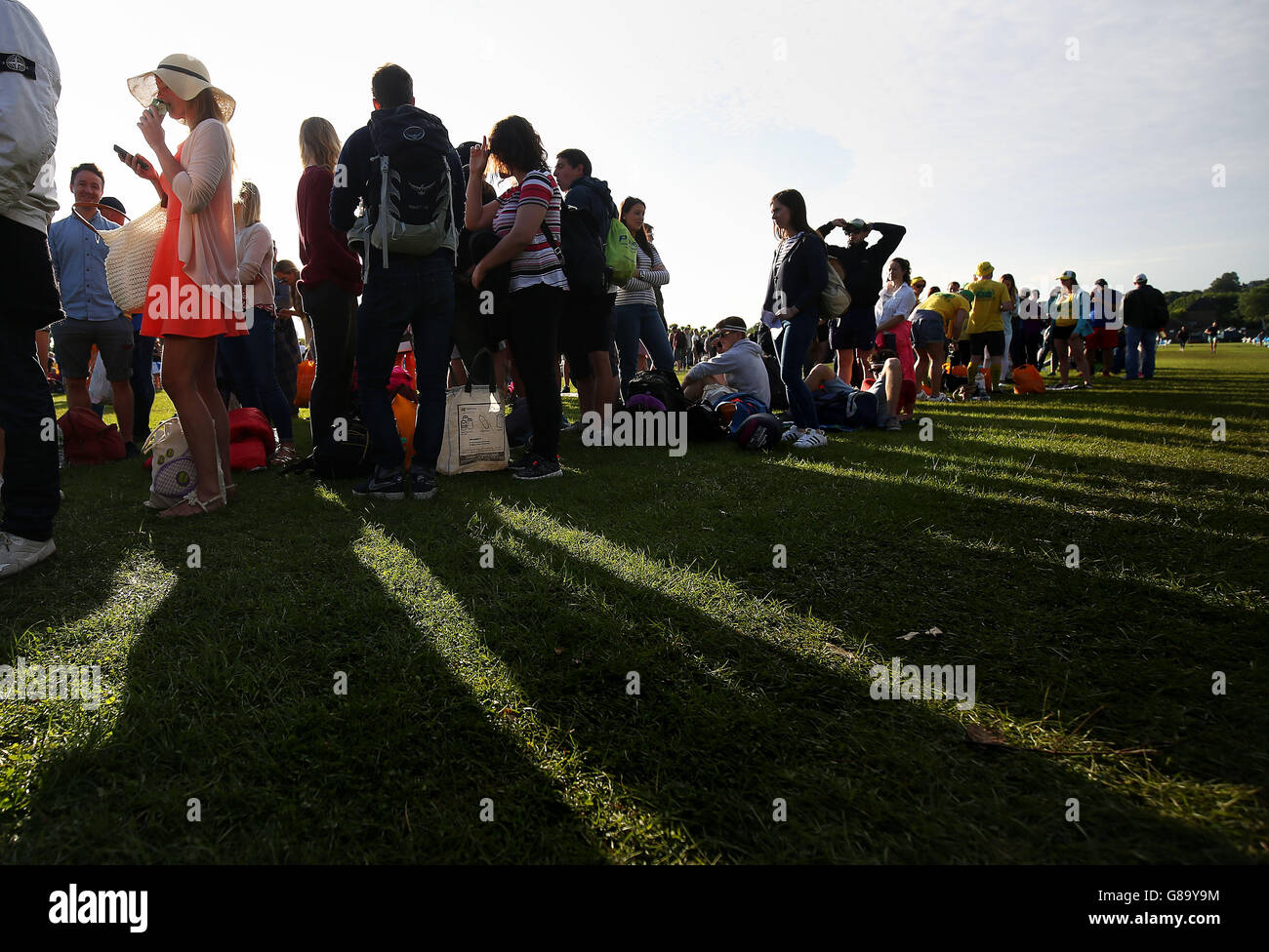 Spectators queue in Wimbledon Park on day two of the Wimbledon Championships at the All England