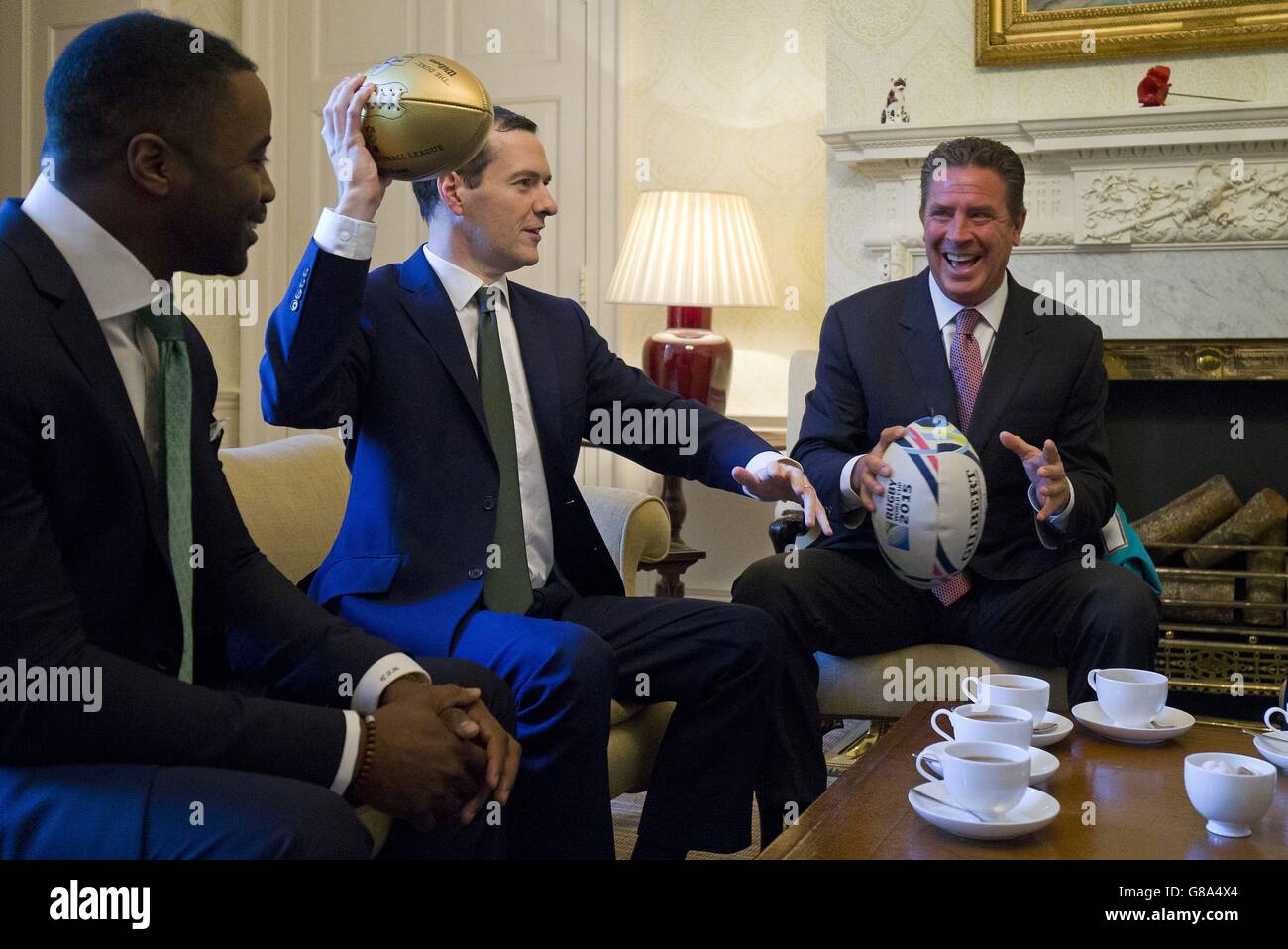 Chancellor of the Exchequer George Osborne as he meets with former American football players Dan Marino (right) and Curtis Martin during their meeting inside 11 Downing Street in London ahead of the Miami Dolphins meeting the New York Jets at Wembley Stadium on Sunday. Stock Photo