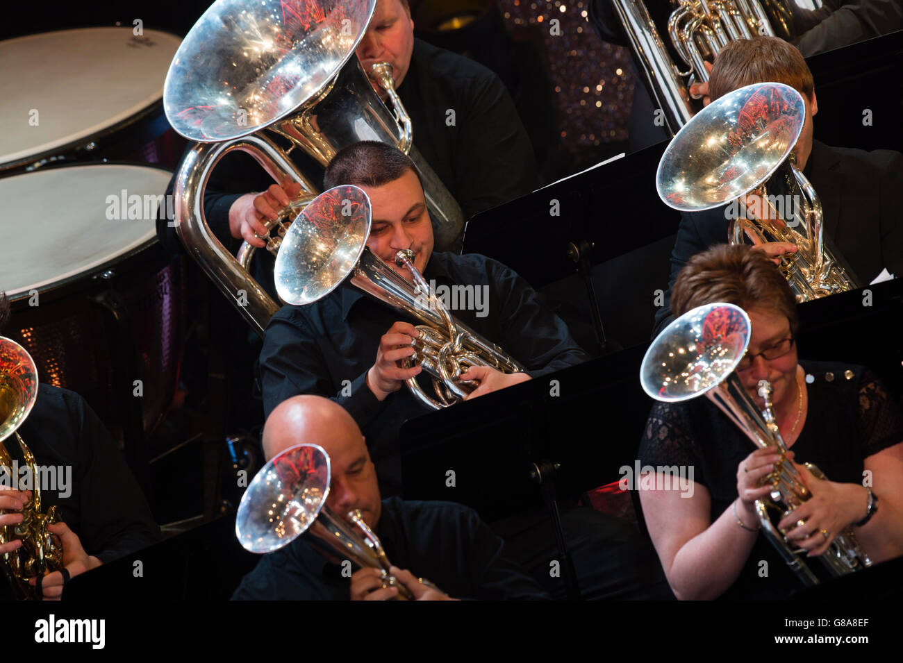 Brass band amateur musicians playing their highly polished horn instruments in a concert,UK