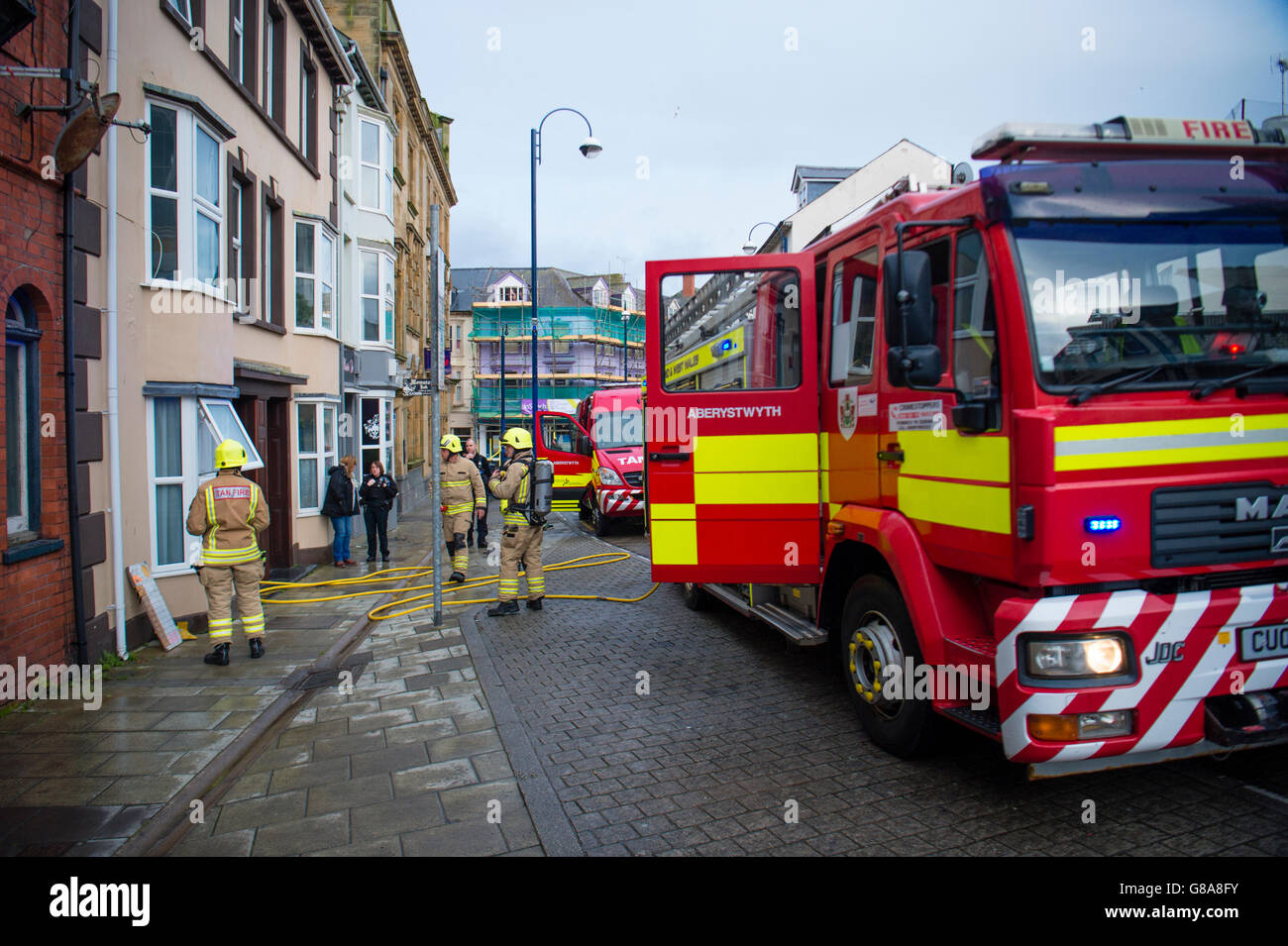 Emergency services Firemen attending to a small kitchen fire in a