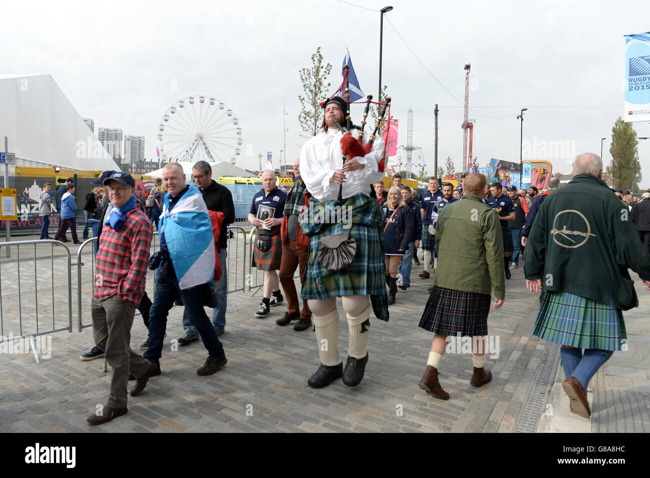 A bagpiper plays outside the fanzone in Newcastle ahead of the World Cup Match at St James' Park, Newcastle. Stock Photo