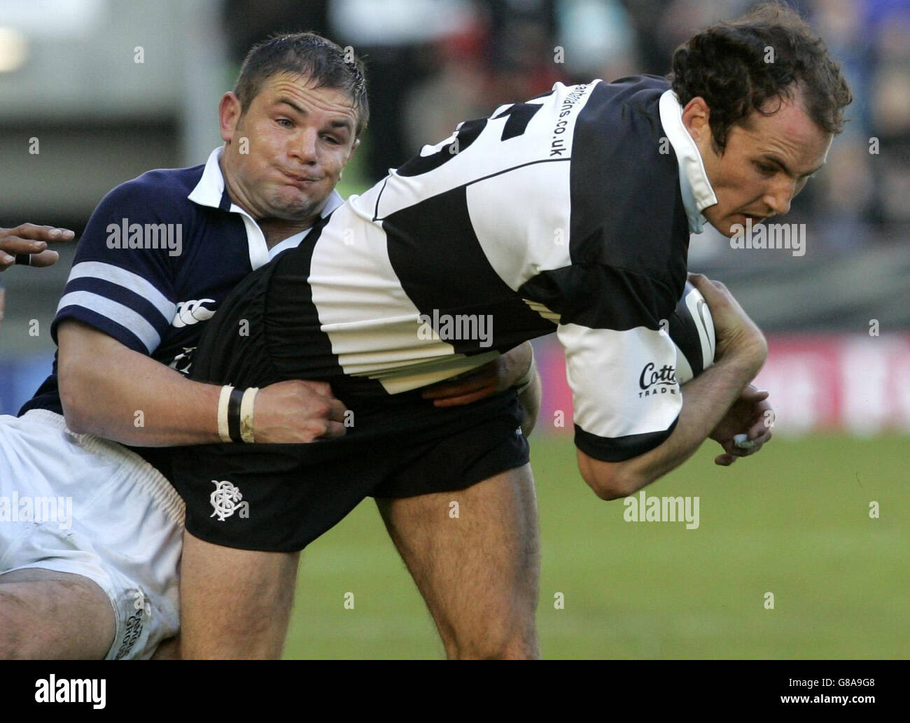 Scotland's Gordon Ross (L) tackles Babarians' Girvan Dempsey. Stock Photo