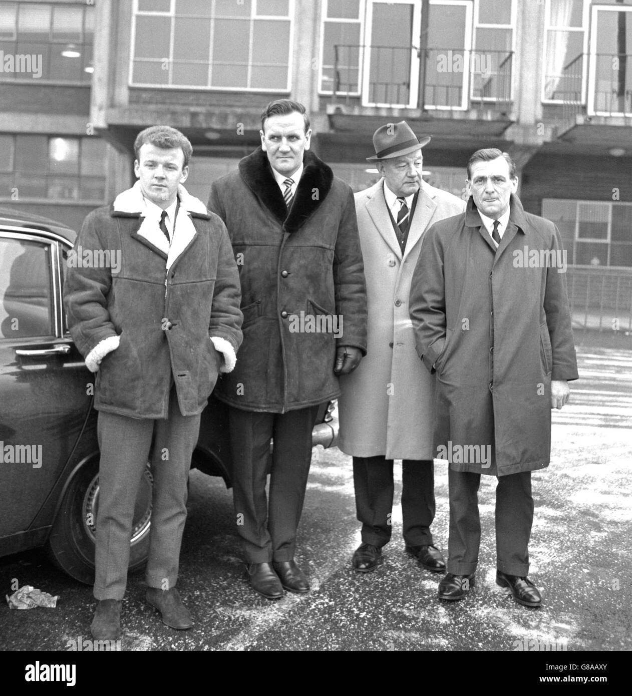 Billy Bremner and Leeds United officials leave Elland Road for Sheffield, where the player is to make a personal appearance before the FA Disciplinary Committee. (l-r) Billy Bremner, manager Don Revie, secretary Cyril Williamson, and trainer Les Cocker. Stock Photo