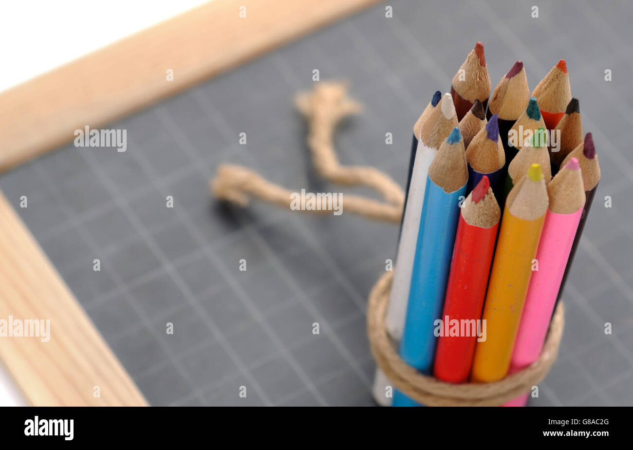 colored pencils stringed on a slate Stock Photo