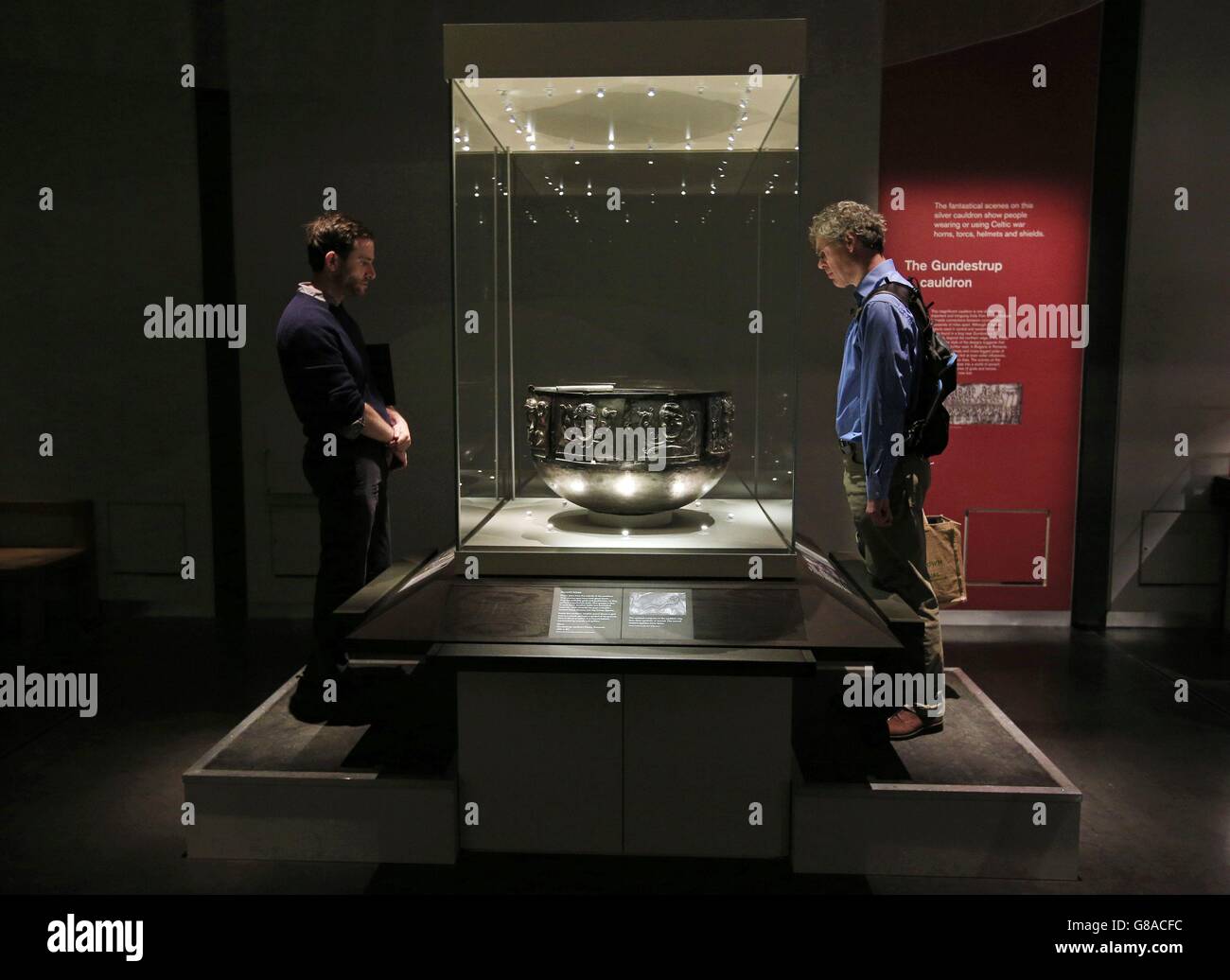 Visitors look at the Gundestrup Cauldron during a press view of the exhibition, Celts: art and identity at the British Museum, London. Stock Photo