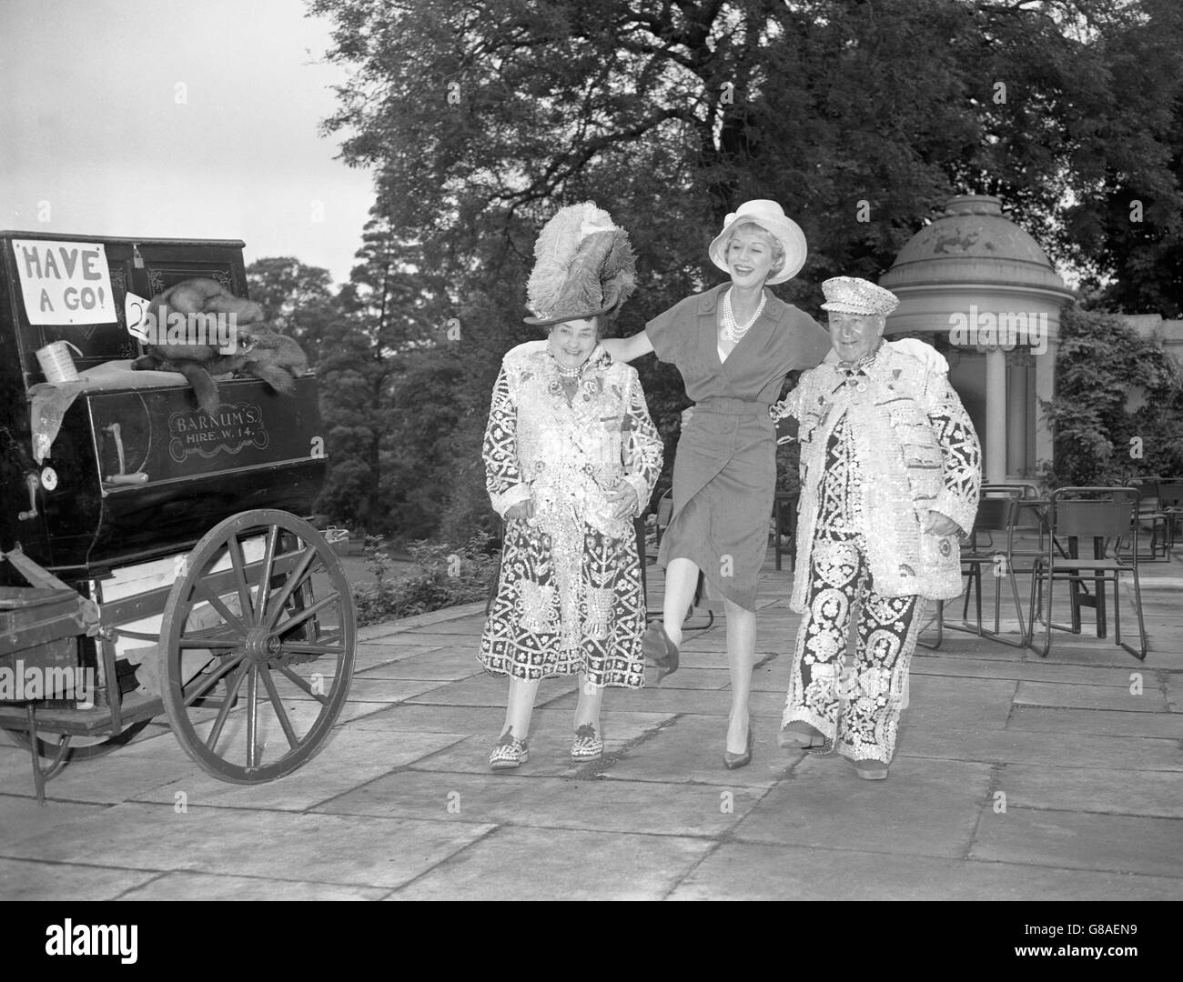 Actress Margaret Leighton does the Lambeth Walk with Pearly King and Queen Bert and Beck Matthews of Hampstead, during a Garden Party at the Holme, Inner Circle, Regent's Park, which was held in aid of the Sunshine Homes for Blind Babies. The Sunshine Homes are conducted by the Royal National Institute for the Blind, London. Stock Photo