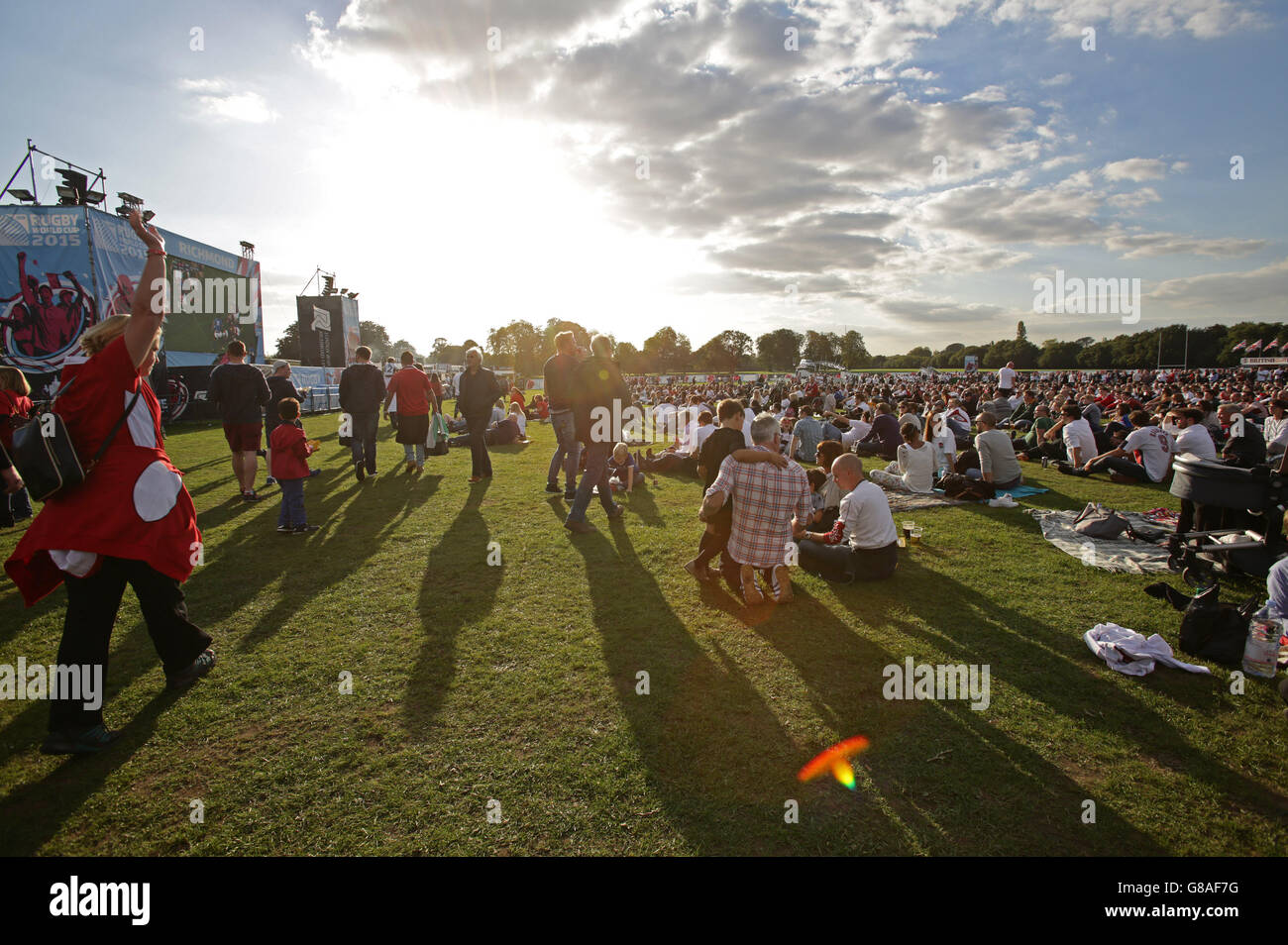 Fans watching rugby on a giant outdoor screen at the Fanzone in Old