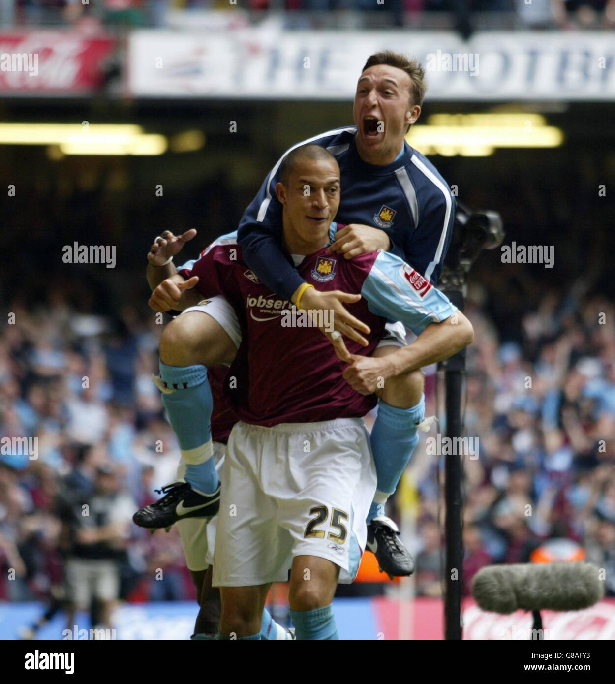 Soccer - Coca-Cola Football League Championship - Play Off Final - Preston North End v West Ham United - Millennium Stadium. West Ham United's Bobby Zamora celebrates with Mark Noble (top) after scoring. Stock Photo