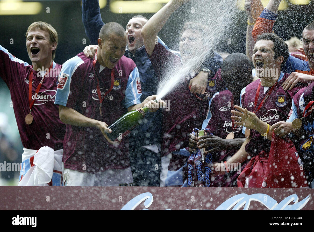 West Ham United's Bobby Zamora (2nd from left) sprays the champagne as he celebrates with his team-mates after winning the Coca-Cola Championship play-off final. Stock Photo