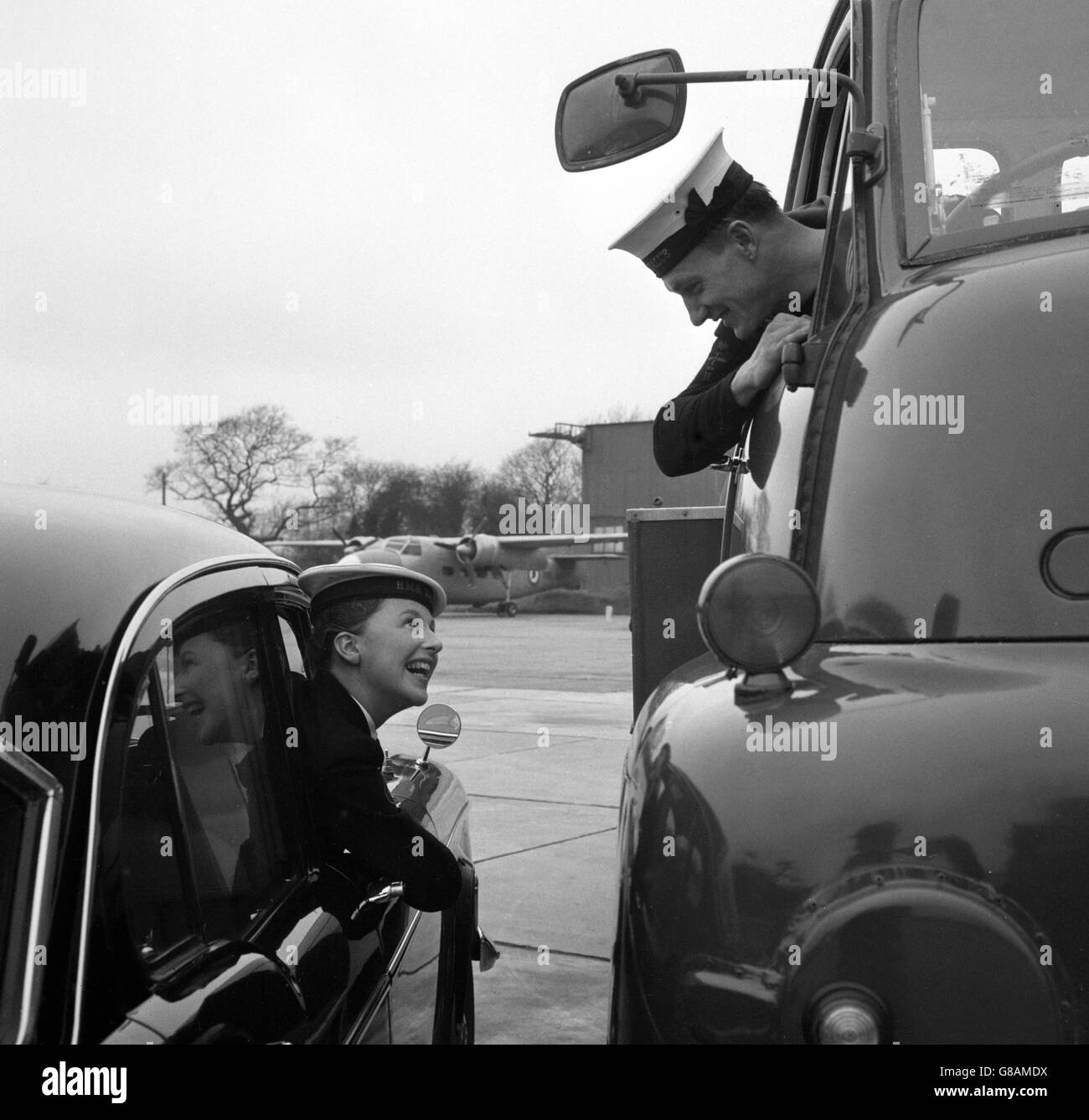 Leading Airman Sam Clarke and his wife, Leading Wren Janet Clarke, who both serve at the RNAS station HMS Daedalus at Lee-on-Solent, Hampshire. Sam, from Newtownards, Co. Down, drives heavy vehicles, including the station fire engine. Janet, whose home town is Chepstow, is chauffeuse for Vice-Admiral DCEF Gibson, Flag Officer Naval Air Command. In 1961, Sam was driver for the Admiral when he was in command of the carrier Ark Royal. Stock Photo