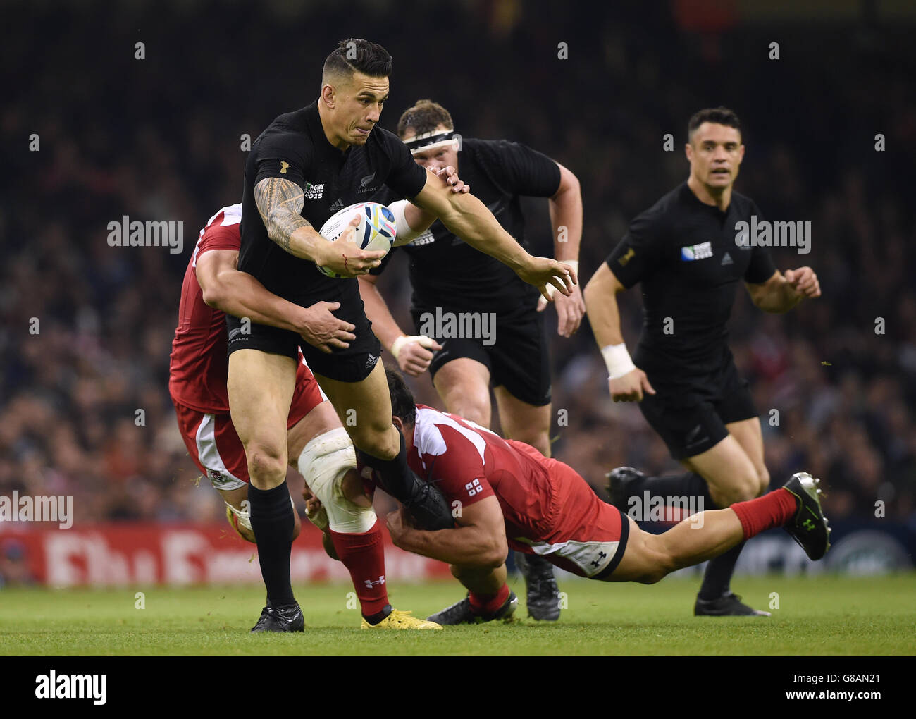 New Zealand's Sonny Bill Williams is tackled by Georgia's Levan Datunashvili (left) and Tamaz Mchedlidze during the Rugby World Cup match at the Millennium Stadium, Cardiff. Stock Photo
