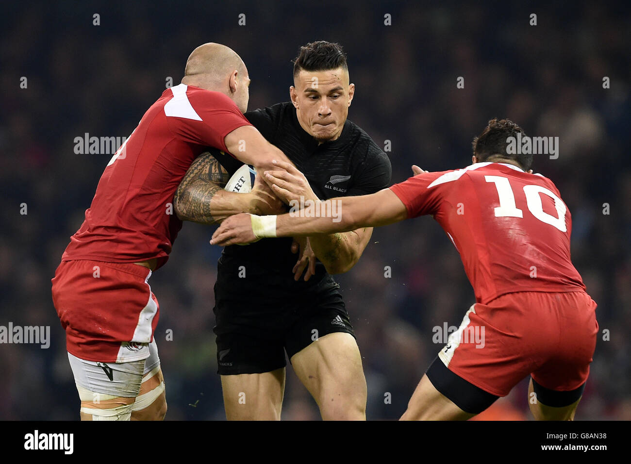 New Zealand's Sonny Bill Williams (centre) is tackled by Georgia's Lasha Lomidze (left) and Lasha Malaguradze during the Rugby World Cup match at the Millennium Stadium, Cardiff. Stock Photo