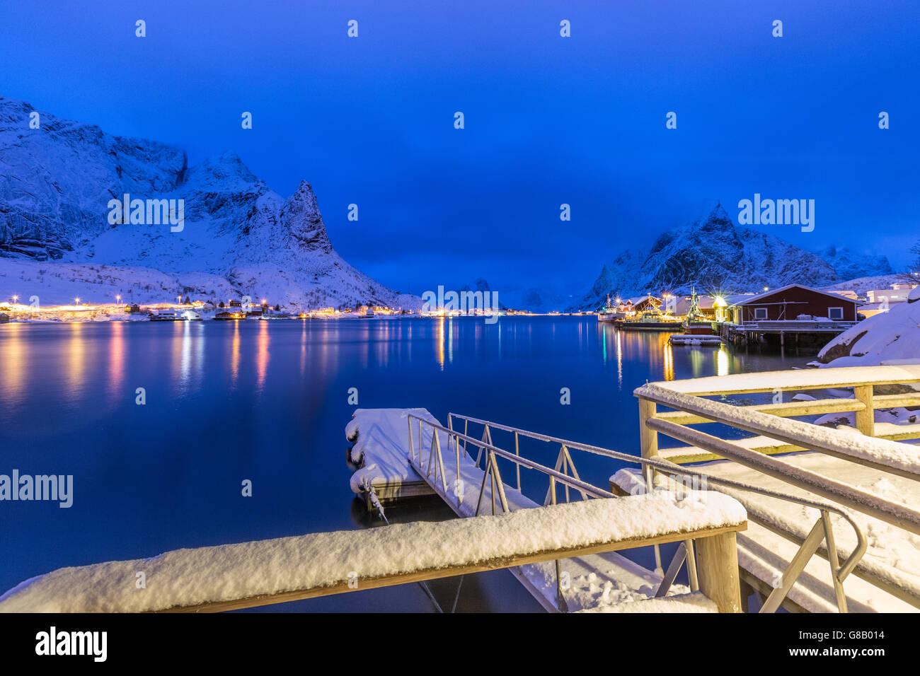 Snowy Peaks Reflected In The Cold Sea At Dusk Reine Lofoten Islands