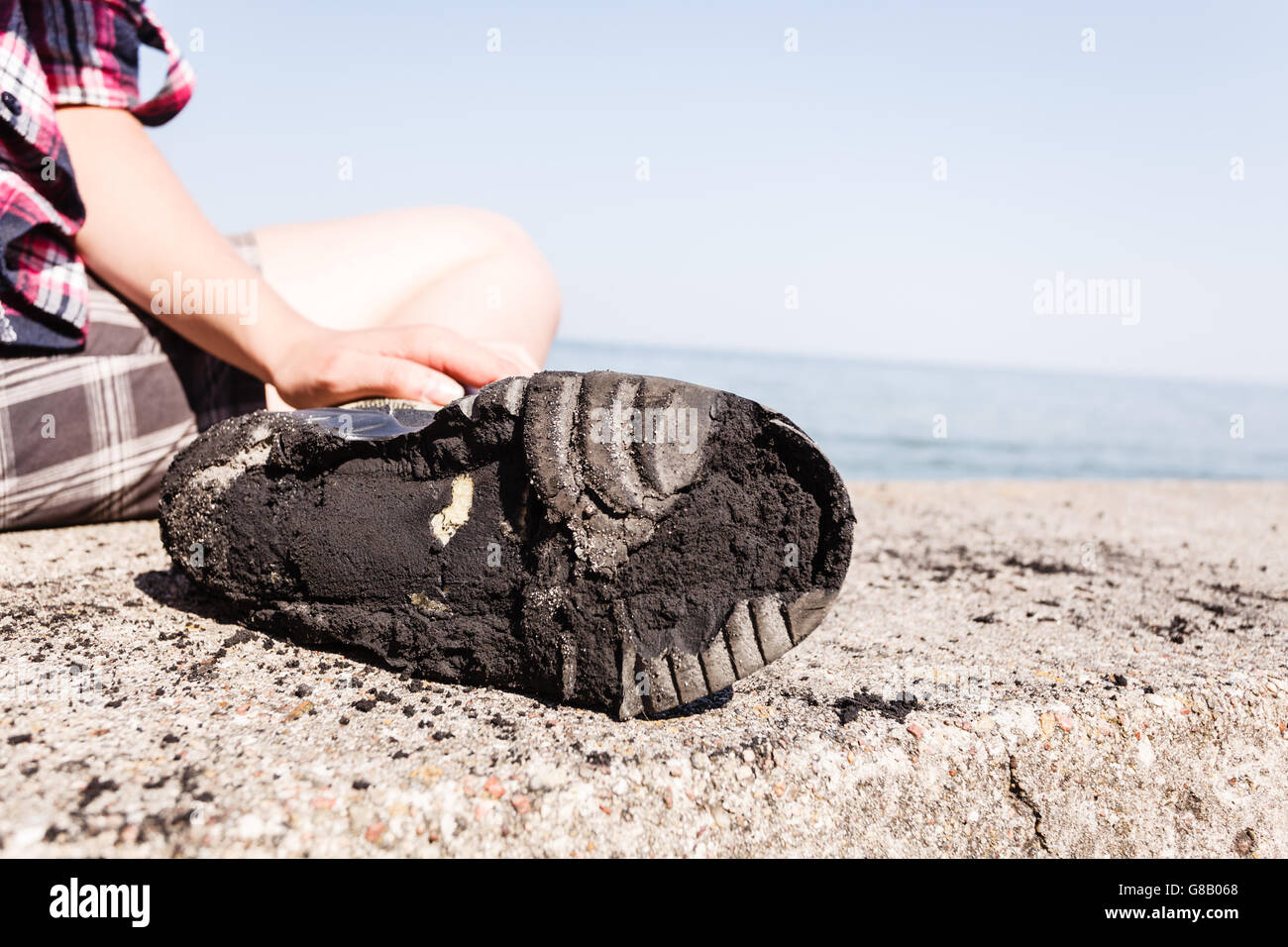 Outdoor trip holidays relax footwear concept. Checking on worn out shoe. Person with destroyed old boot. Stock Photo