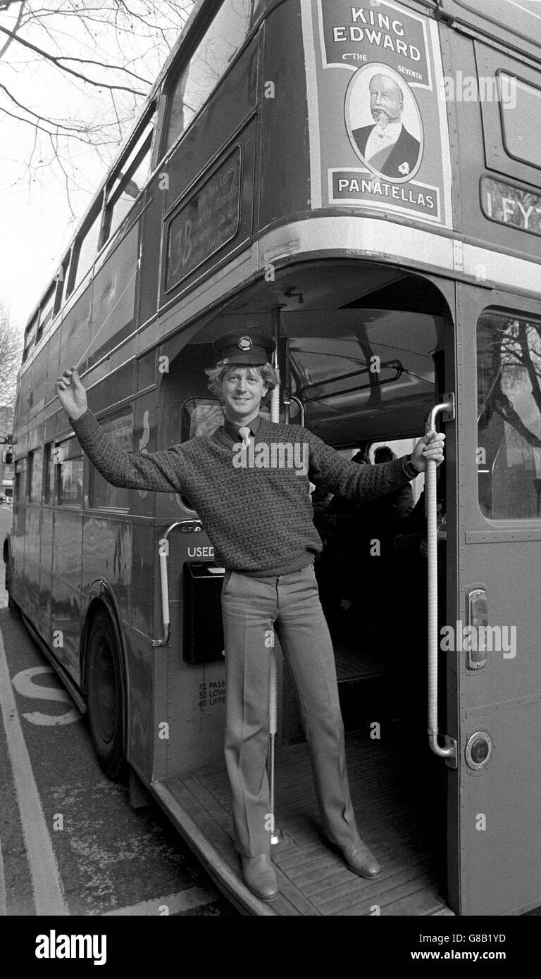 Barry Wordsworth, Principal Conductor and Musical Director of the Sadler's Wells Opera Company, well in tune with his baton plus a busman's hat as he emphasised that the company is arranging special buses to bring theatre goers from various London points to the theatre. Stock Photo