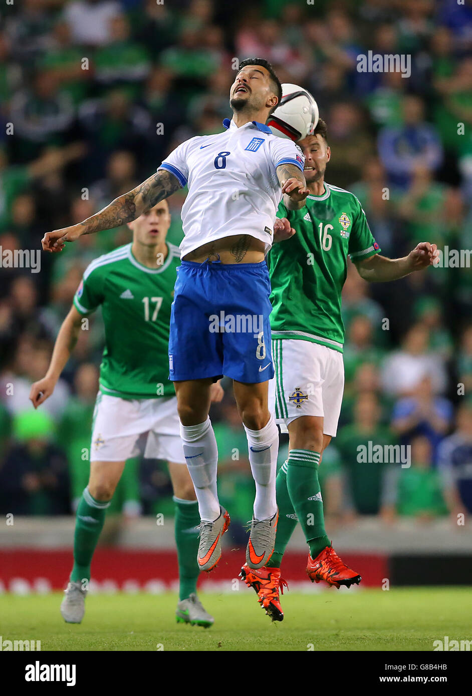 Greece's Panagiotis Kone and Northern Ireland's Oliver Norwood (right) battle for the ball the UEFA European Championship Qualifying match at Windsor Park, Belfast. Stock Photo