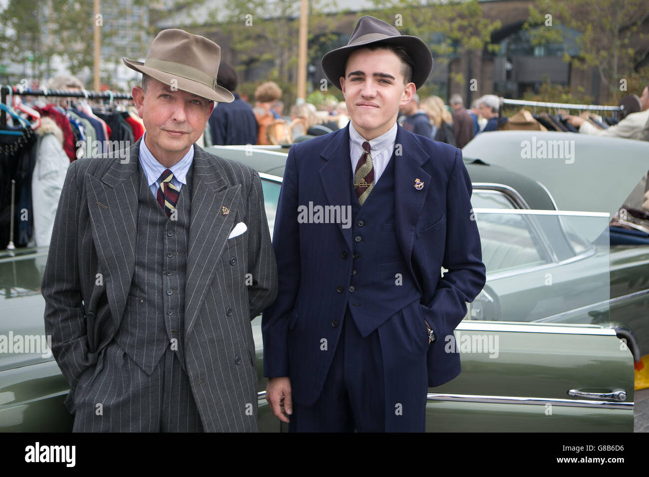 Alan Morris (left) and Jake Drudge (right) pose in front of a vintage Mercedes-Benz 220 SE from 1965 at The Classic Car Boot Sale in Lewis Cubitt Square, London. Stock Photo