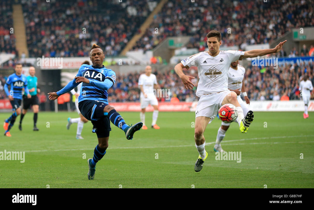 Swansea City's Federico Fernandez (right) and Tottenham Hotspur's Clinton Njie battle for the ball during the Barclays Premier League match at the Liberty Stadium, Swansea. Stock Photo