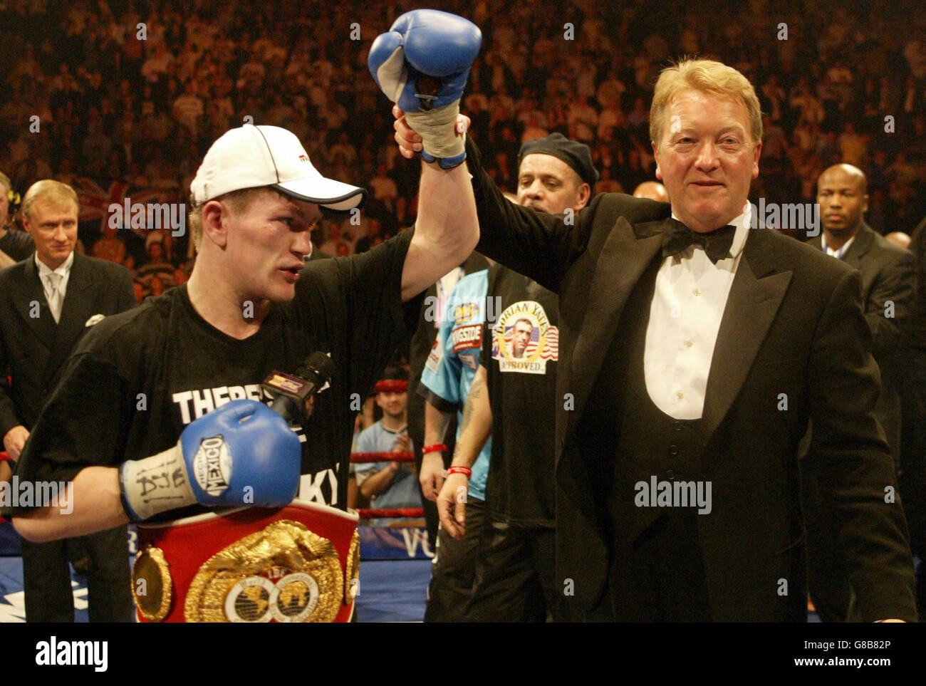 Ricky Hatton has his arm lifted by promoter Frank Warren as they celebrate victory over Kostya Tszyu. Stock Photo