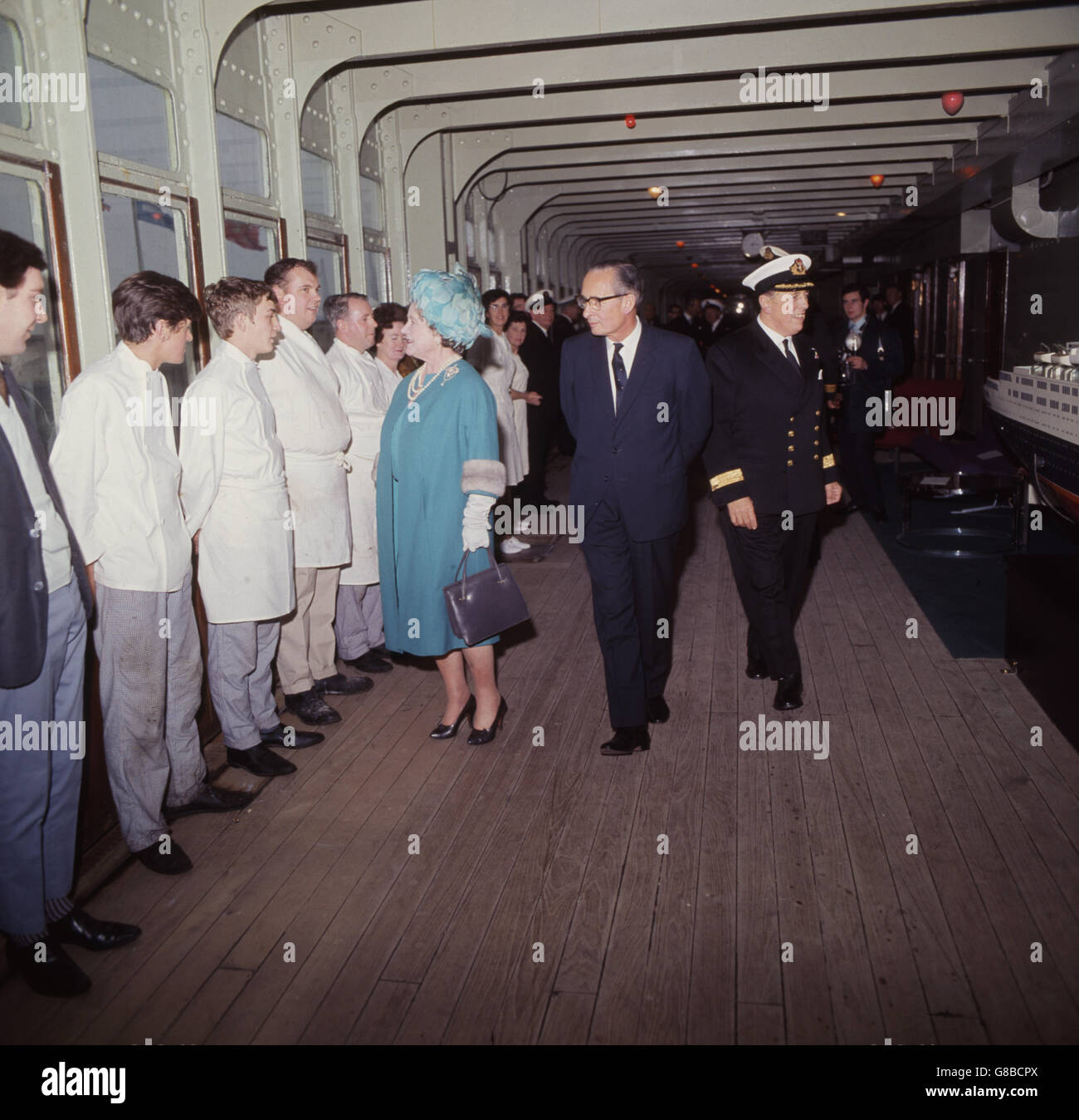 The Queen Mother meets members of the ship's complement during her farewell visit to the liner Queen Elizabeth at Southampton. With her are Sir Basil Smallpeice, Cunard Chairman, and captain Geoffrey Thrippleton Marr, Commodore. The liner will be retired and berthed in Florida. Stock Photo