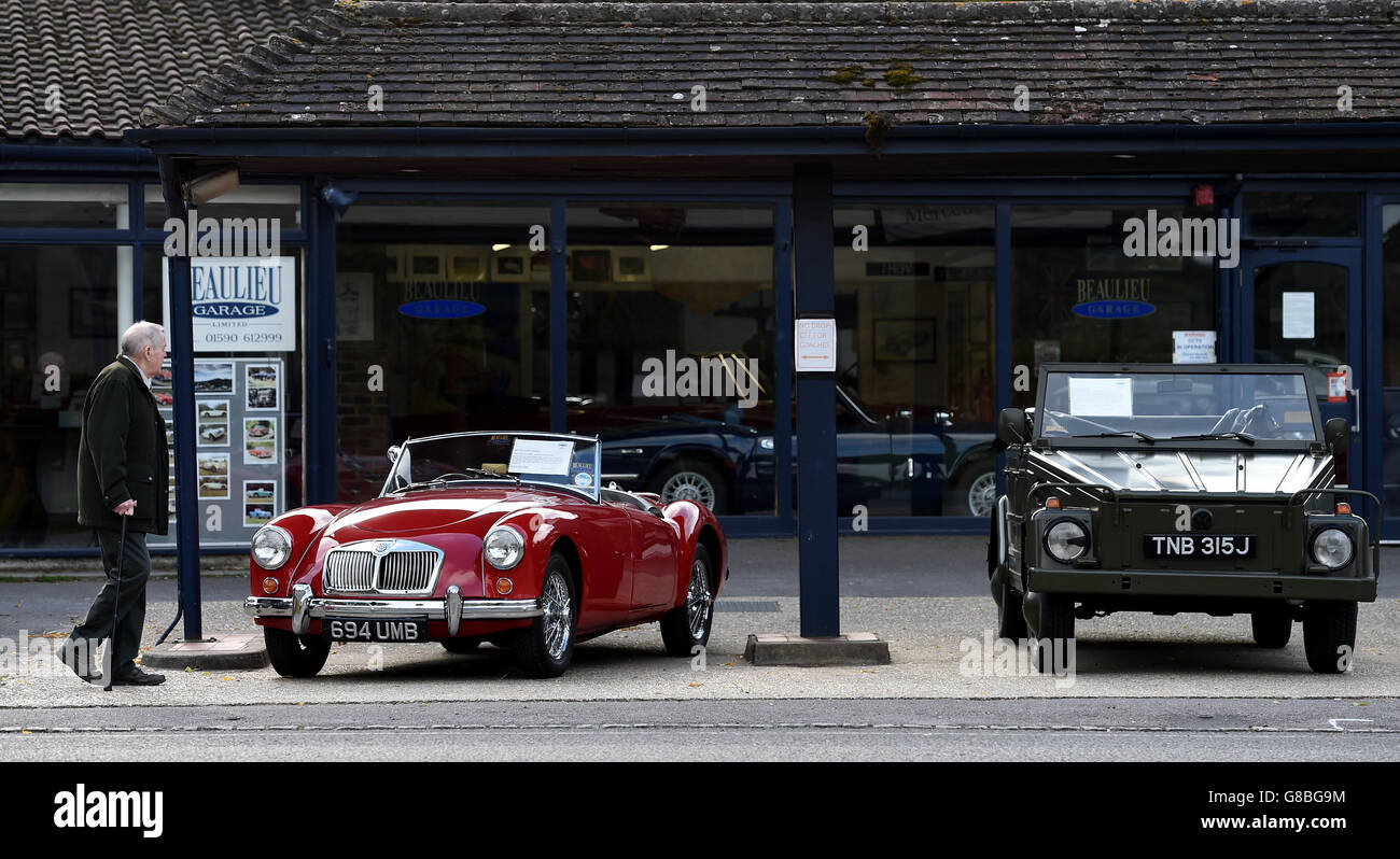A gentleman looks at classic cars as he passes Beaulieu garage on the outskirts of Beaulieu Village in the New Forest, which was recently voted one of the best places in the UK to live Stock Photo