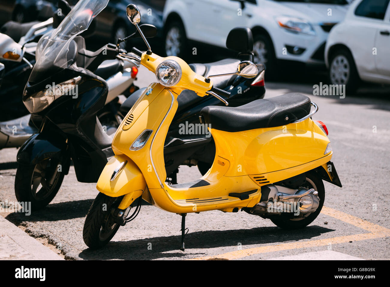 Seville, Spain - June 24, 2015: Yellow Piaggio Vespa vintage sprint motor scooter motorbike motorcycle parked in city. Stock Photo